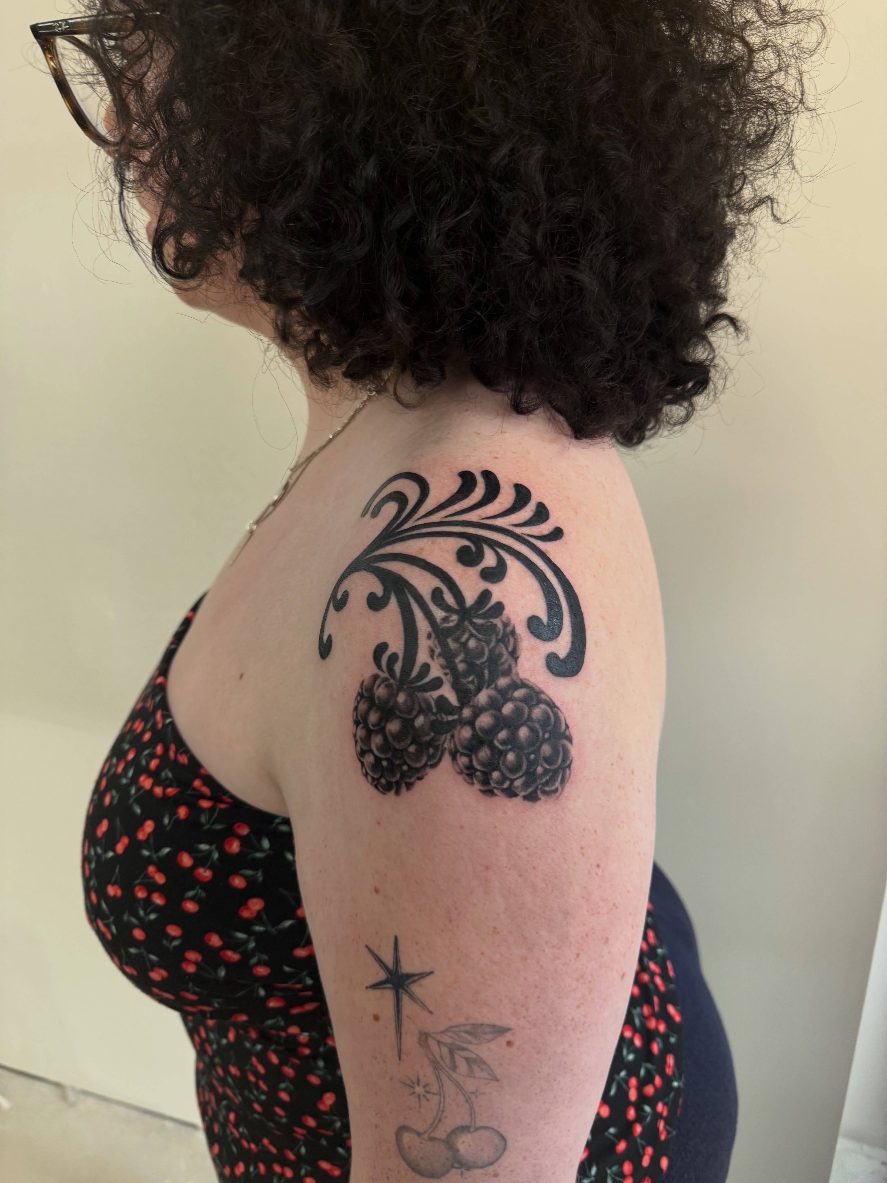 Blackberries black and grey tattoo on the shoulder by Ava Nilou