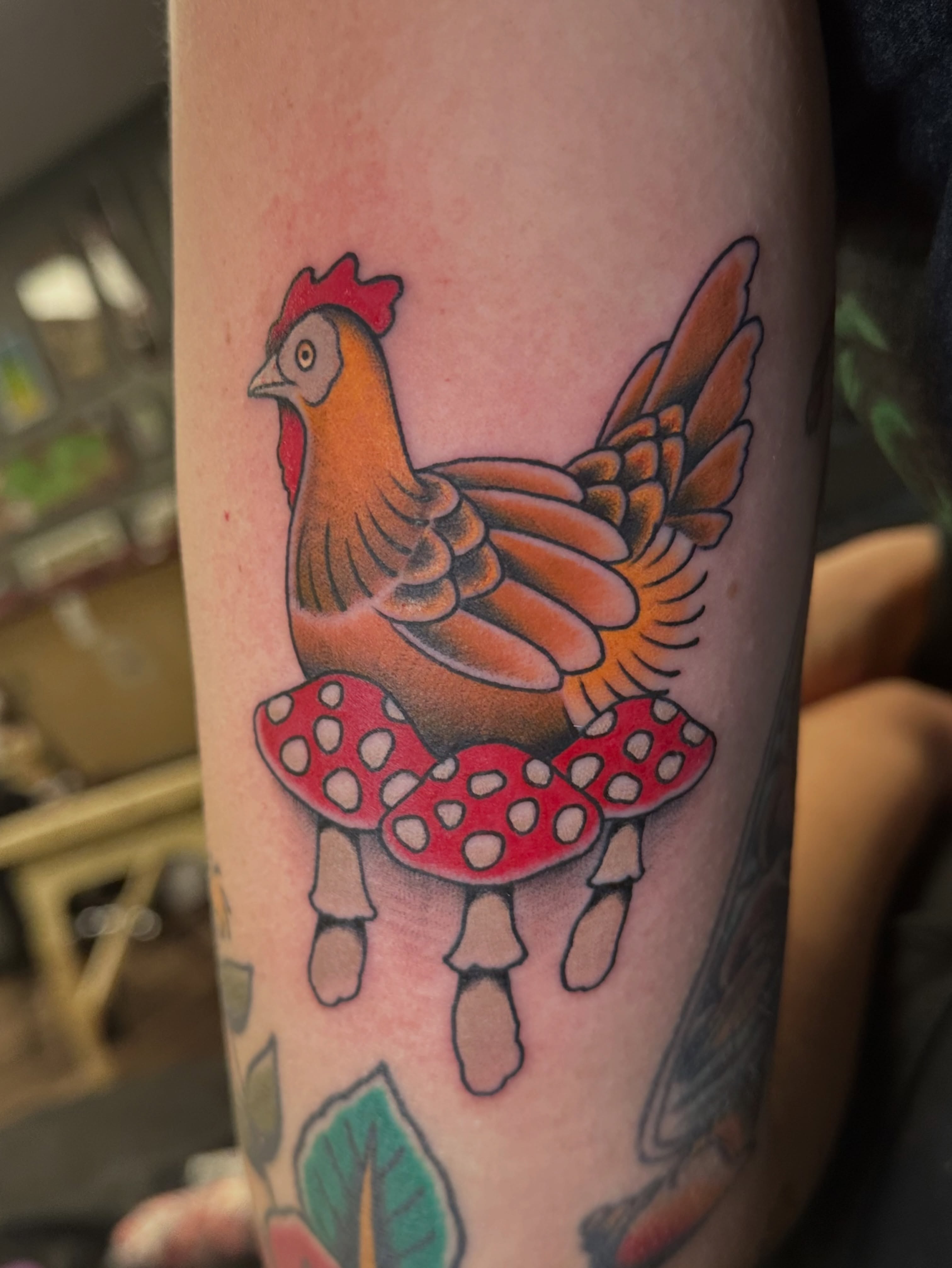 Rooster on mushrooms American traditional tattoo on the forearm by Lauren Howard Tattoos