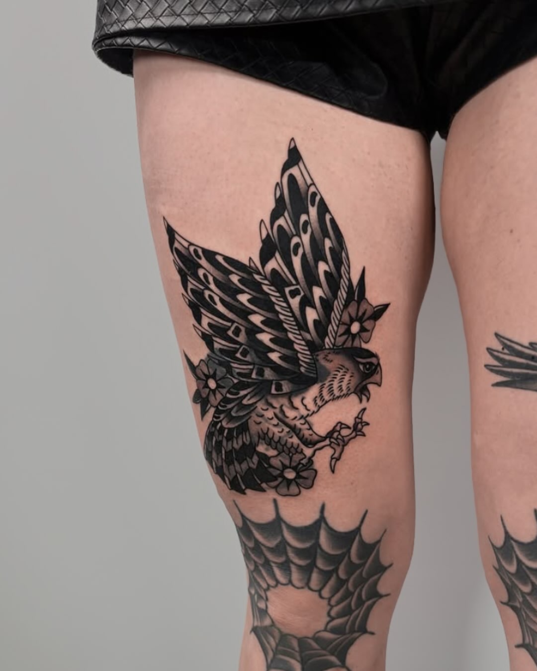 Hawk black and grey tattoo on the thigh by Lorelei