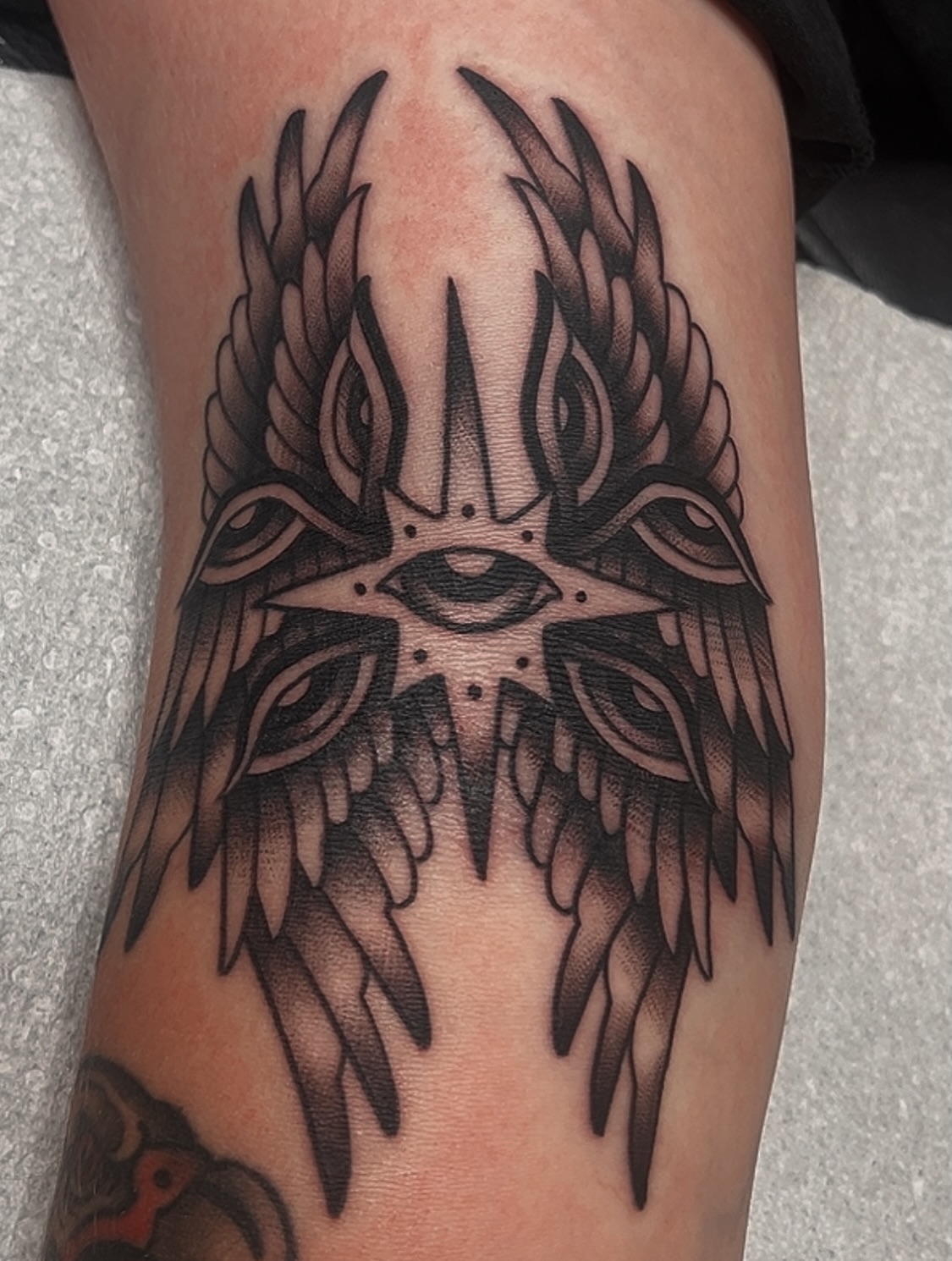 Wings and eye black and grey tattoo on the forearm by Las Vegas Tattoo Artist
