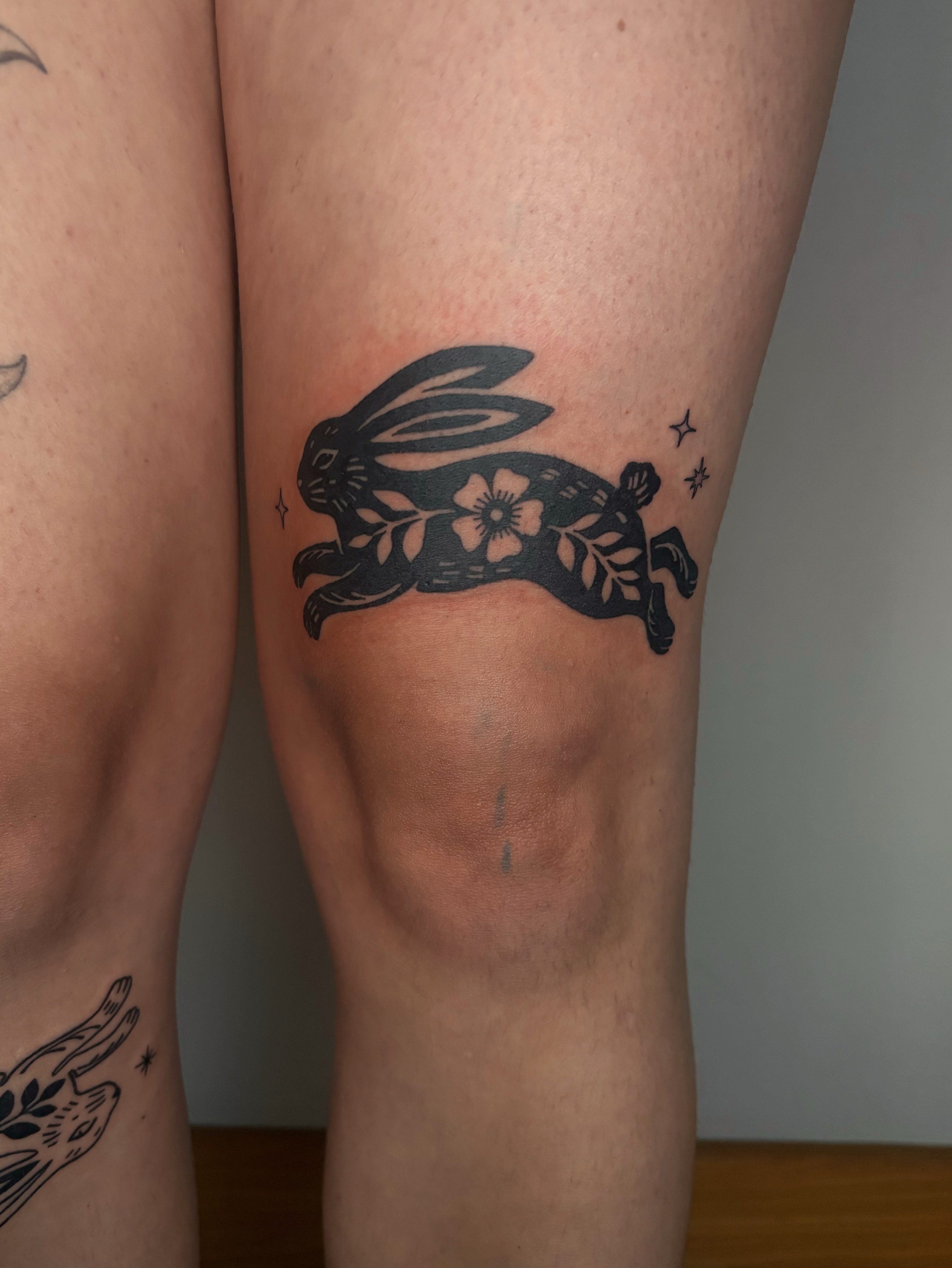 Hare with flowers black and grey tattoo on the thigh by Abigail, San Francisco, California