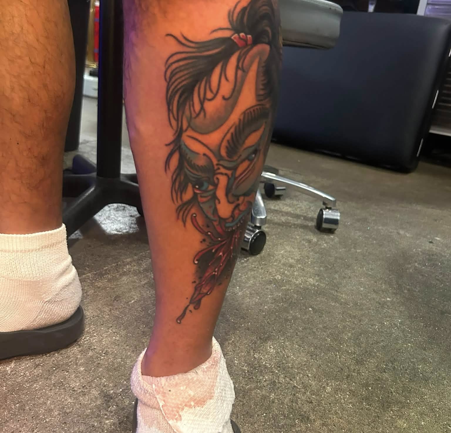 Woman's face realism tattoo on the calf by Daemion