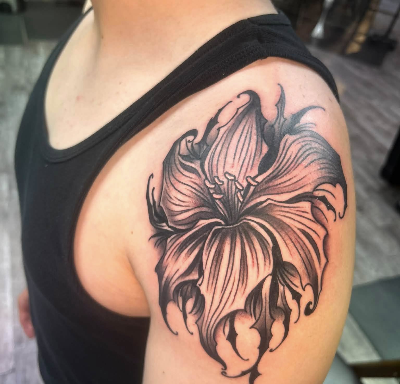 Flower black and grey tattoo on the shoulder by Daemion
