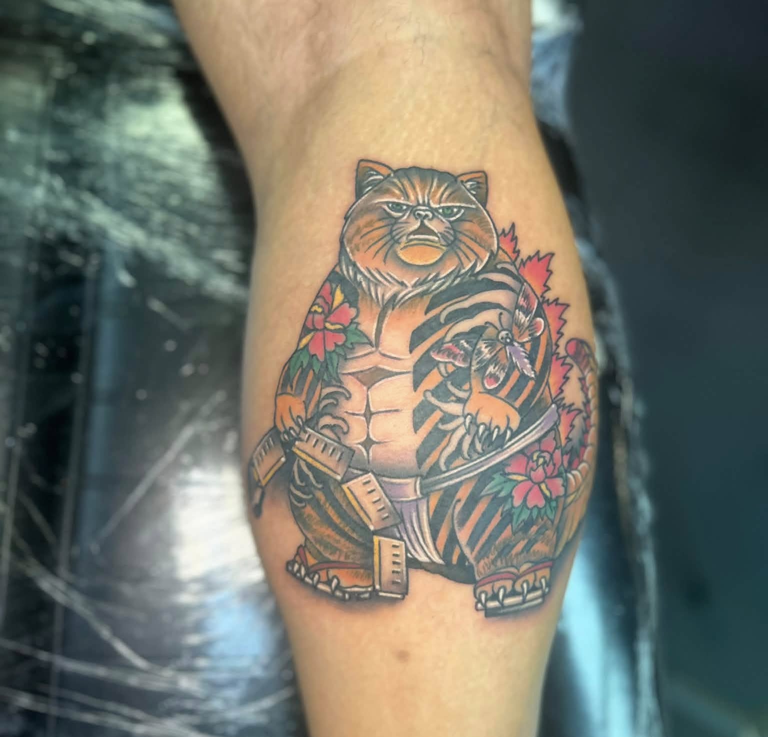 Fat cat with tiger stripes American traditional tattoo on the thigh by Daemion