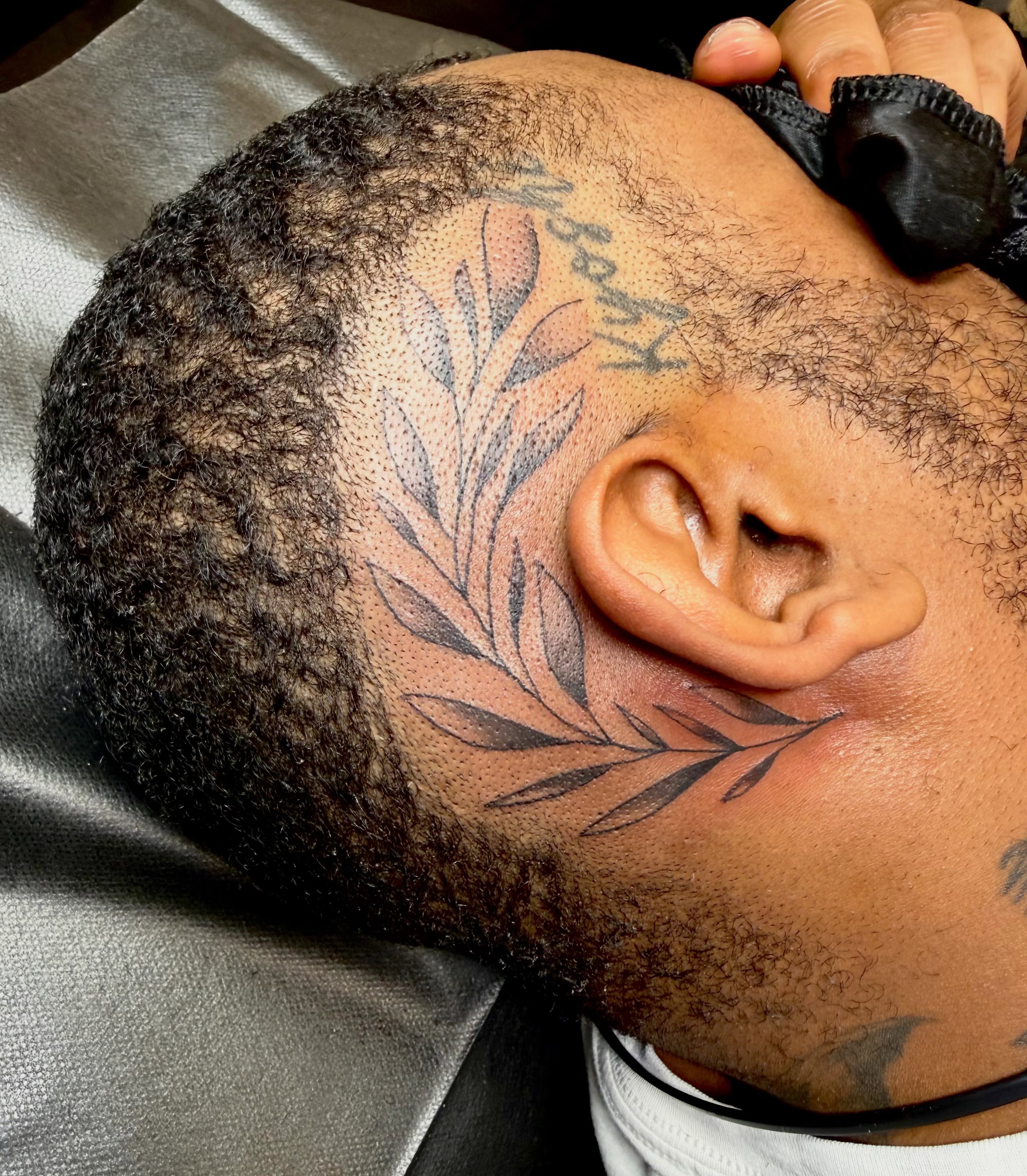 Leaf dotwork tattoo on the neck by Jerry Thomas
