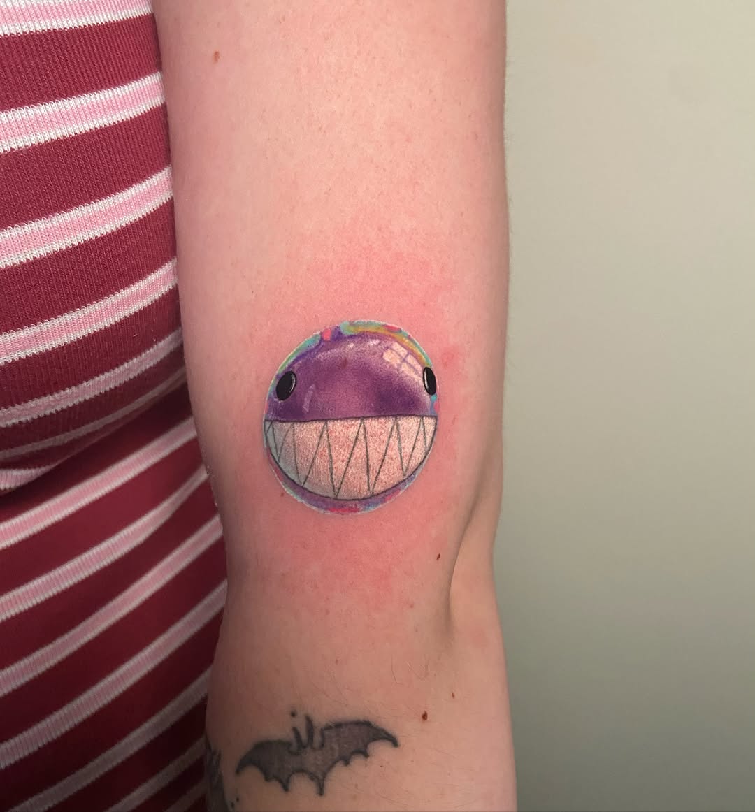 Purple fish watercolor tattoo on the forearm by Ezra Gonda