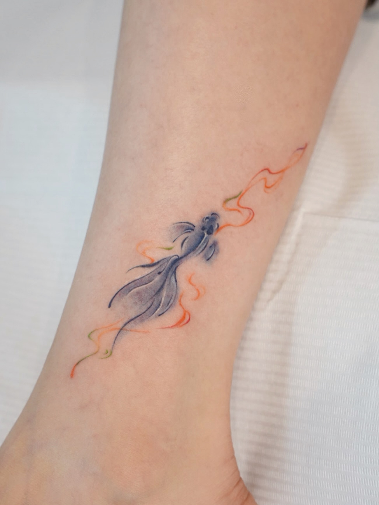 Fish watercolor tattoo on the forearm by 𝕁𝕖𝕞, Richmond, British Columbia