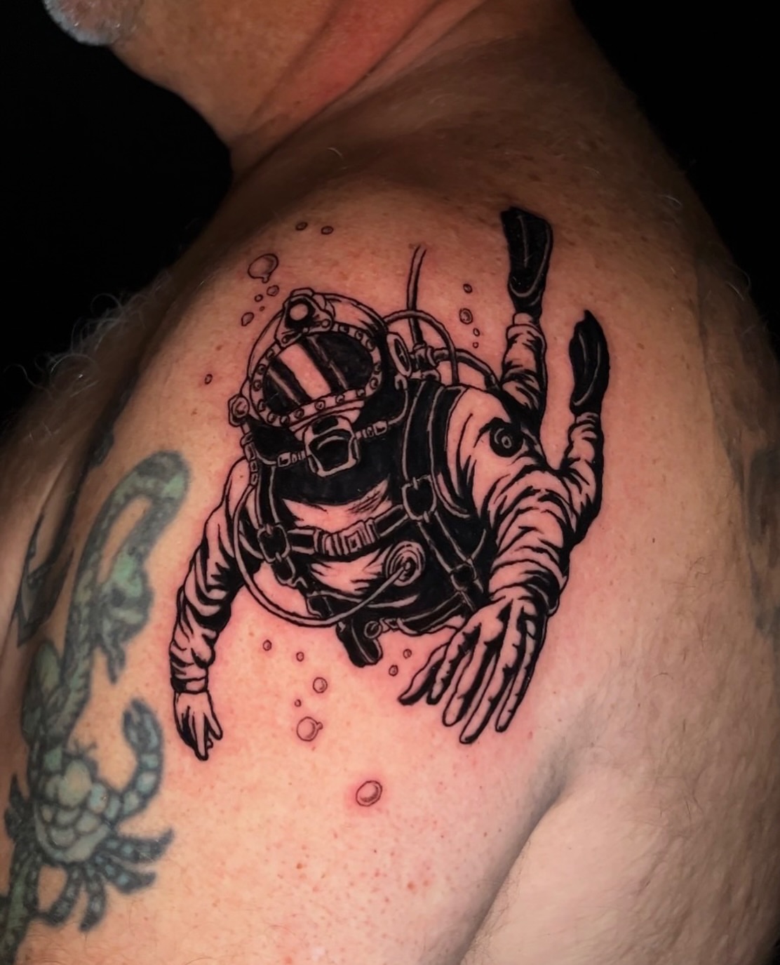 Diver black and grey tattoo on the shoulder by bev