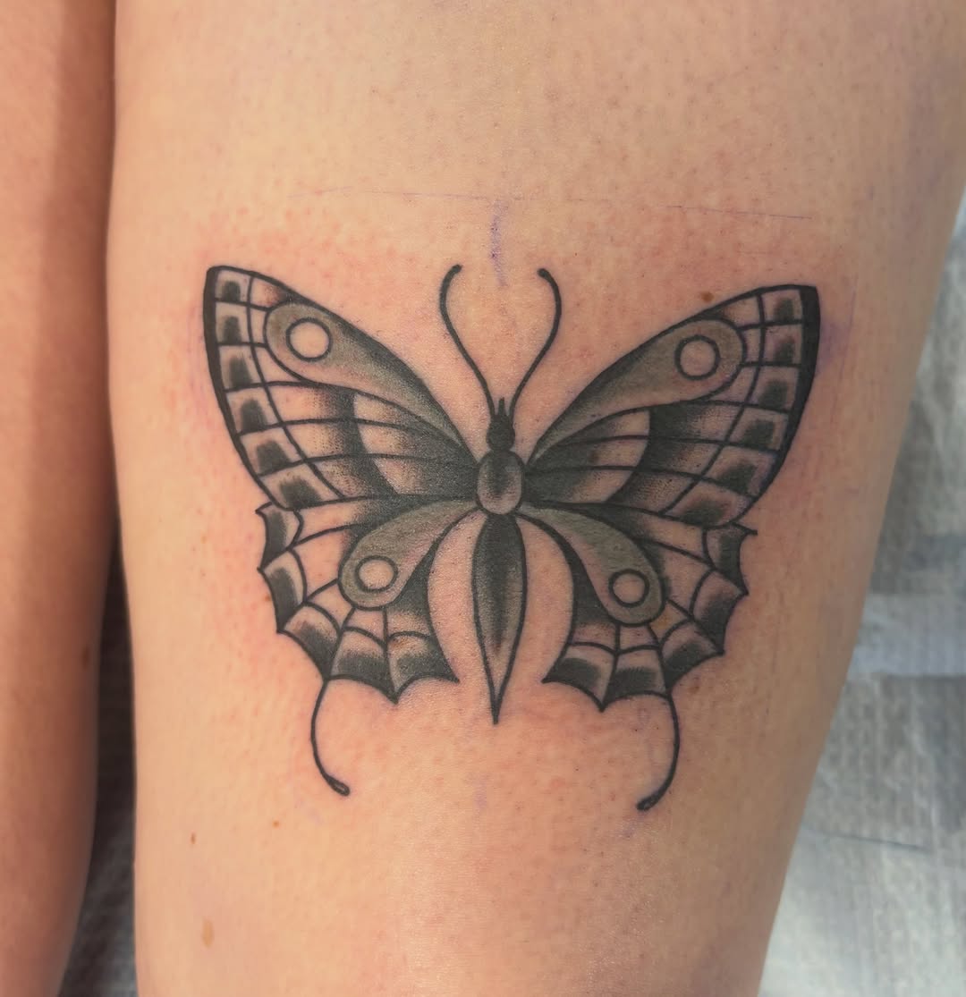 Butterfly black and grey tattoo on the thigh by Nolan Croteau