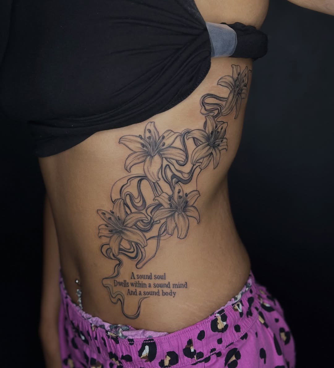 Lilies black and grey tattoo on the ribs by 𝕵𝖊𝖘𝖘𝖆 𝕭𝖎𝖌𝖊𝖑𝖔𝖜, Harrison, New Jersey