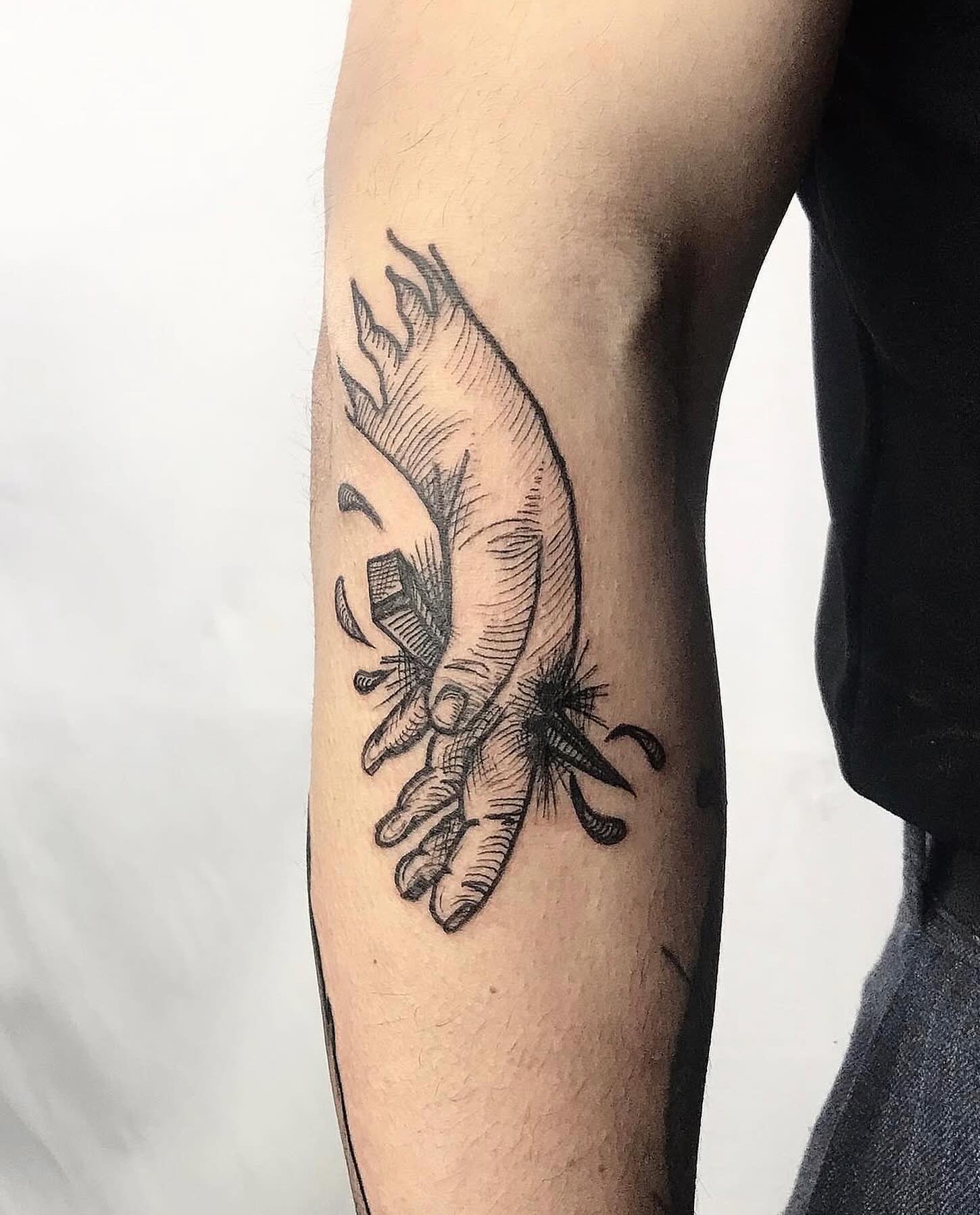Hand with flame black and grey tattoo on the forearm by Yasmine