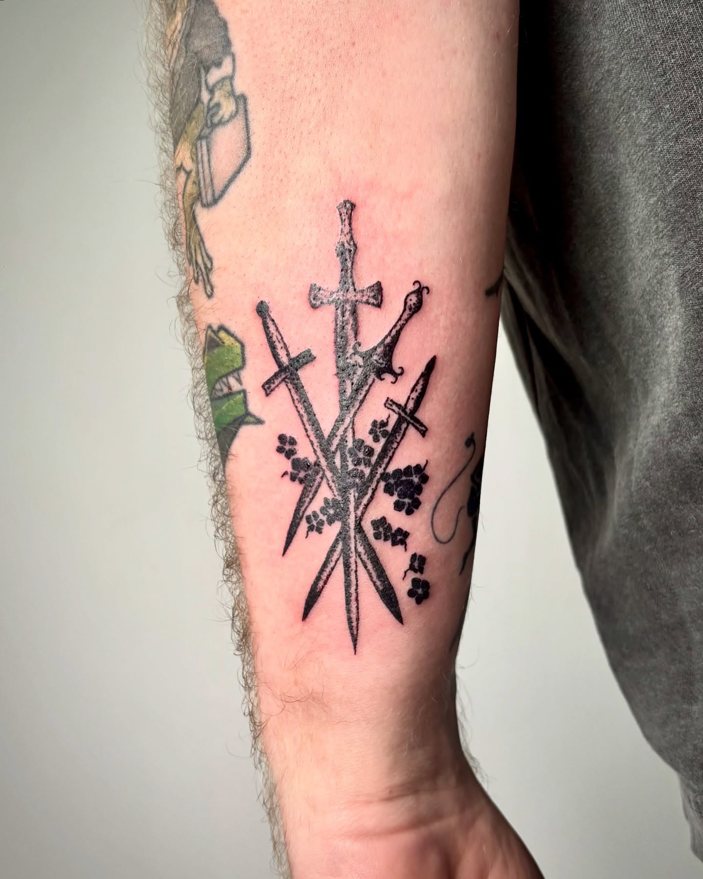 Crossed swords dotwork tattoo on the forearm by kendle