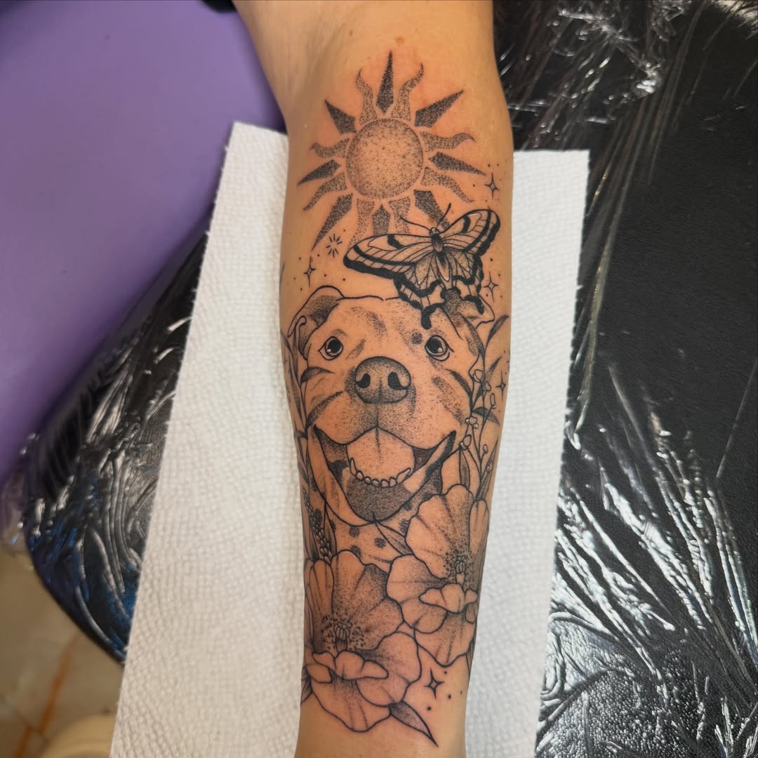 Pitbull and butterfly dotwork tattoo on the forearm by Abby