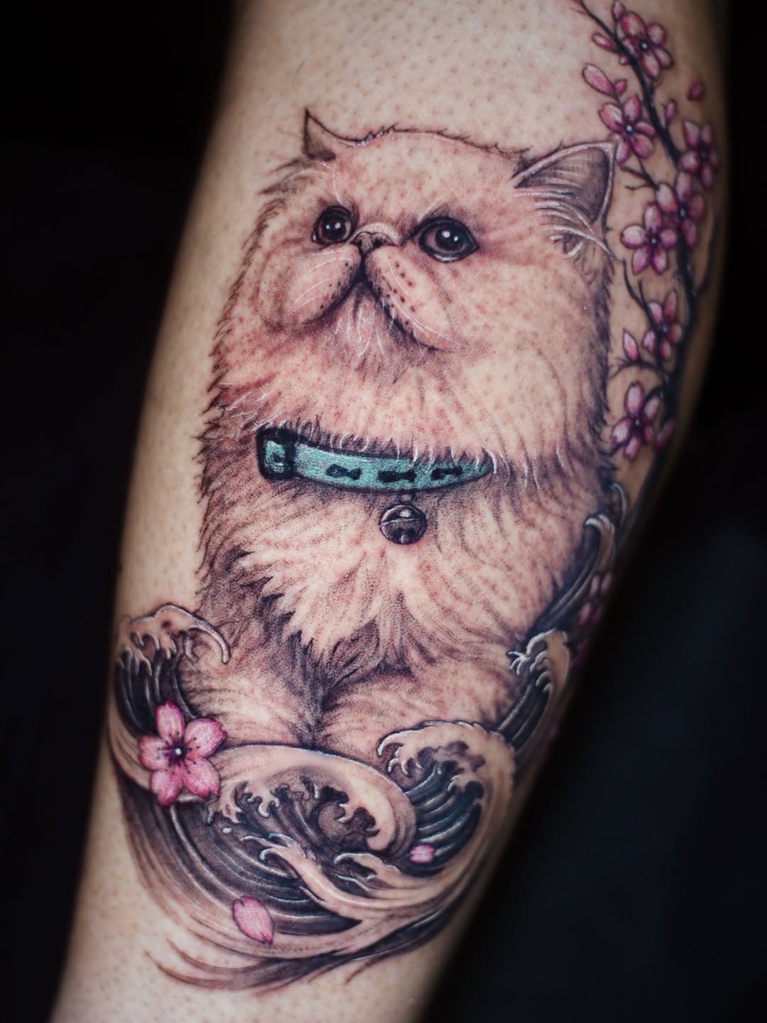 Cat with cherry blossoms and waves tattoo on the forearm by 𝐒𝐡𝐞𝐫𝐥𝐥𝐲