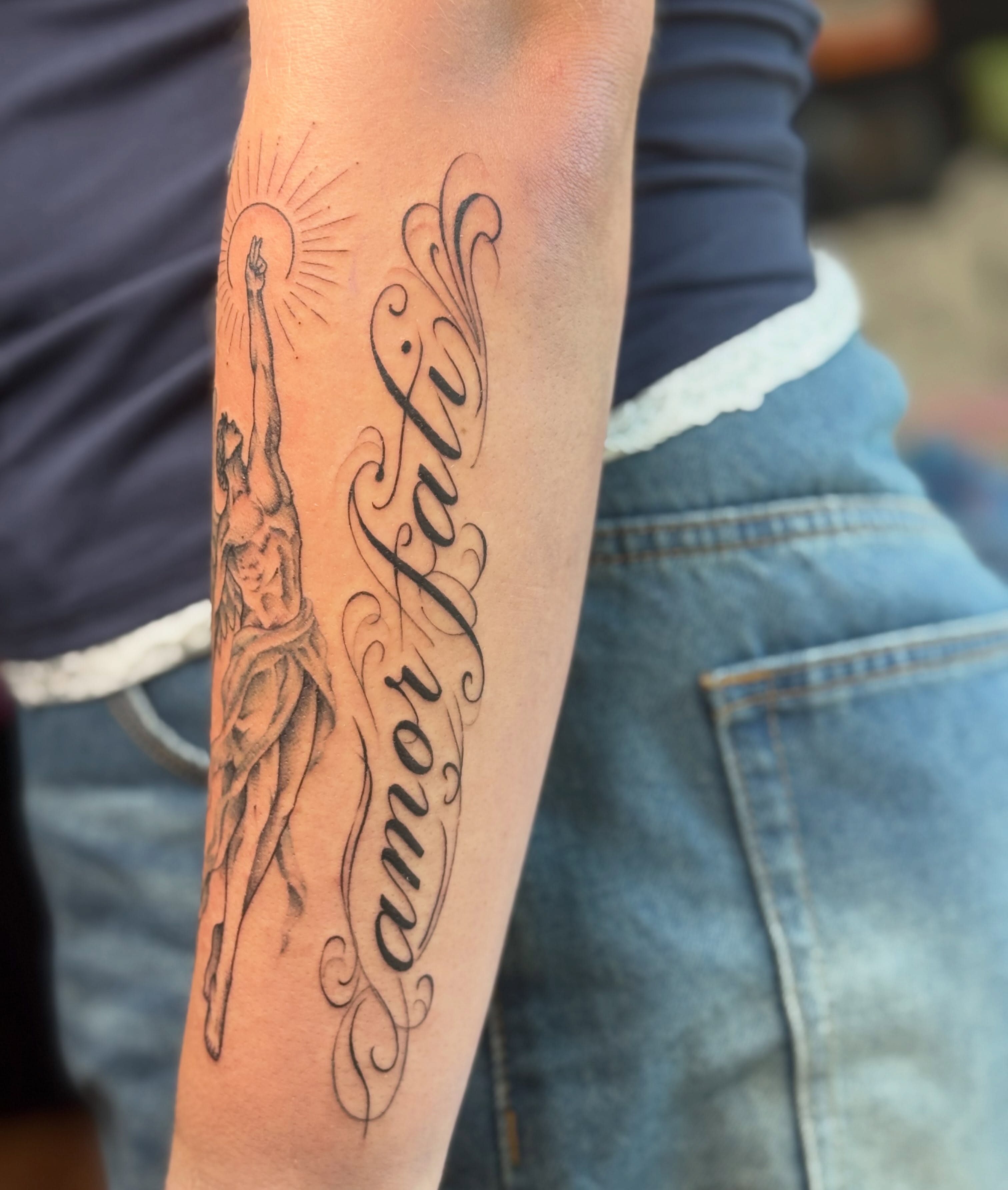 Religious figure black and grey tattoo on the forearm by Tattoo, San Diego, California