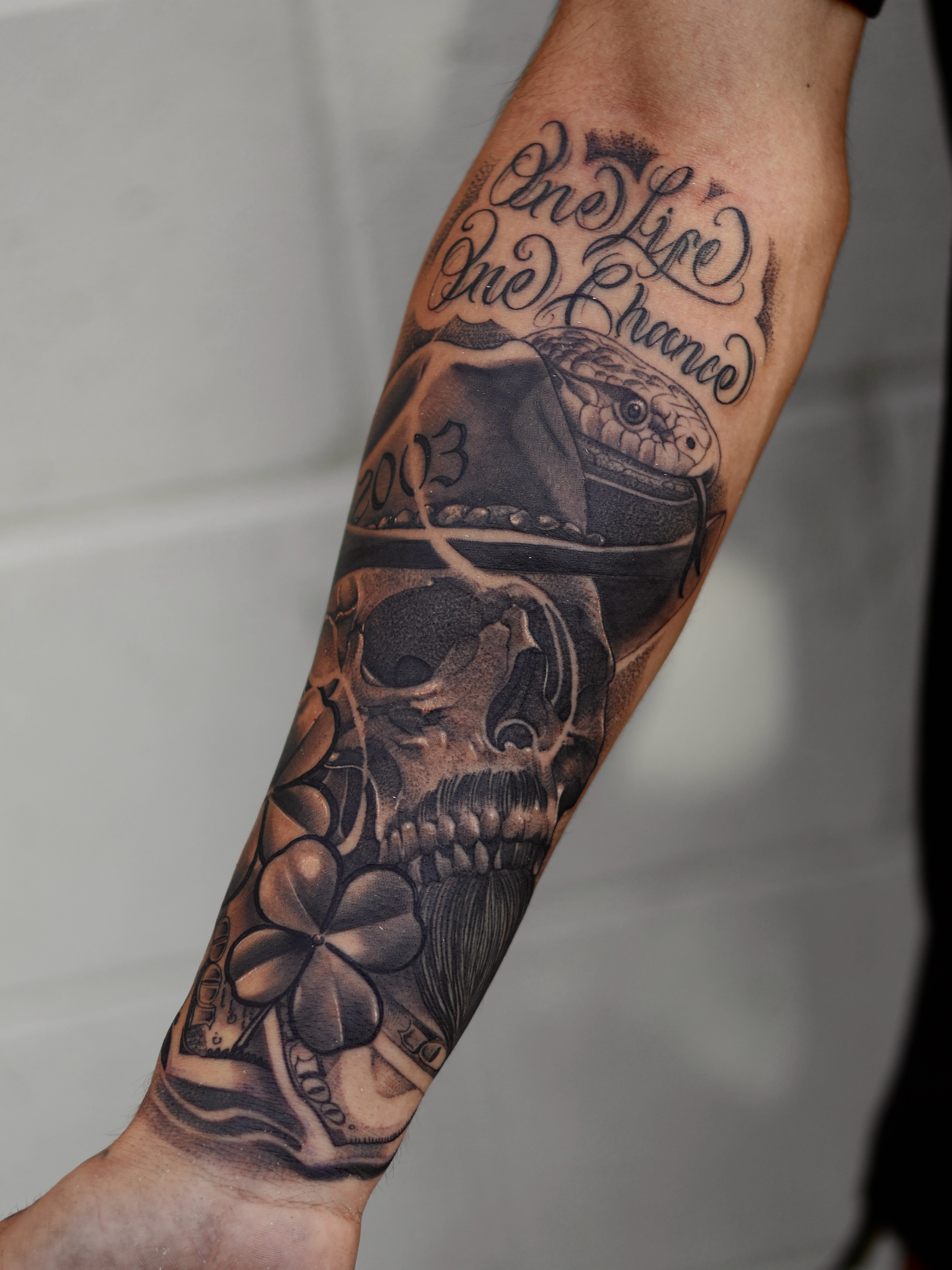 Skull and snake realism tattoo on the forearm by San Diego Tattoo Artist