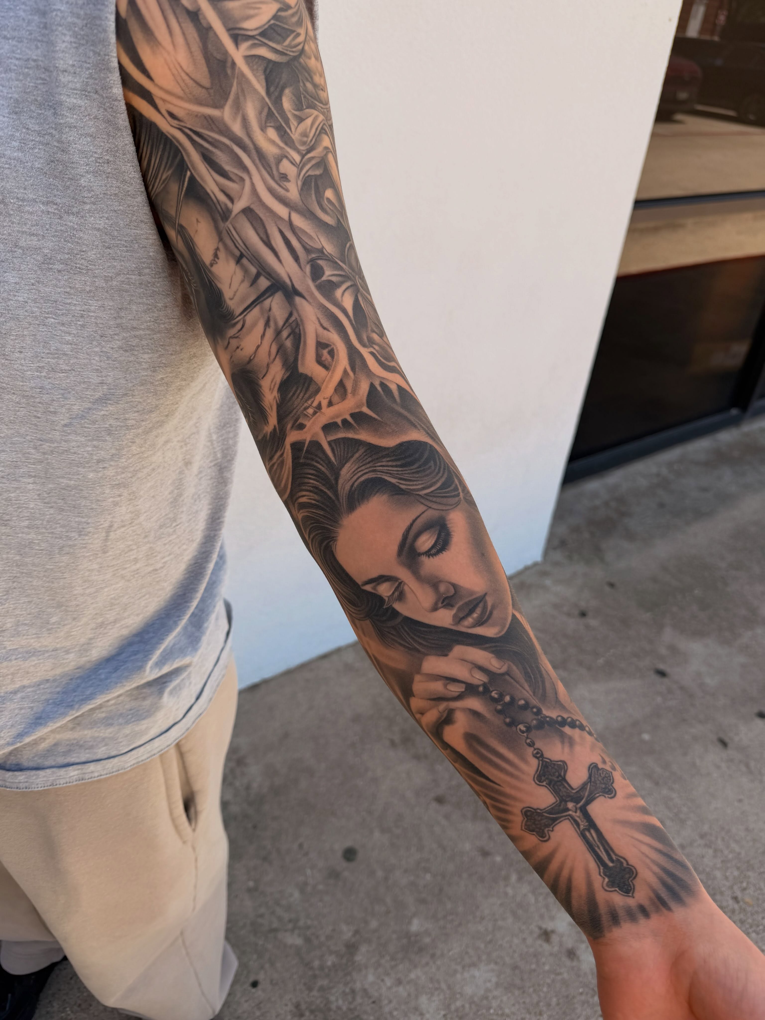 Religious figure realism tattoo on the forearm by Ivan Guadalupe guzman