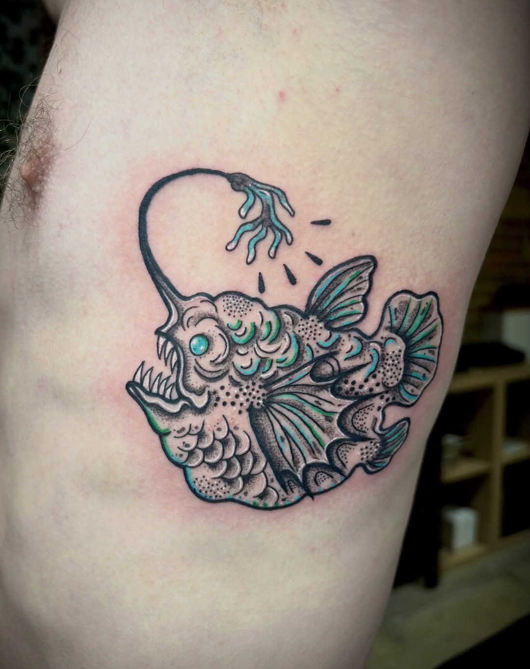 Angler fish American traditional tattoo on the thigh by destiney rose