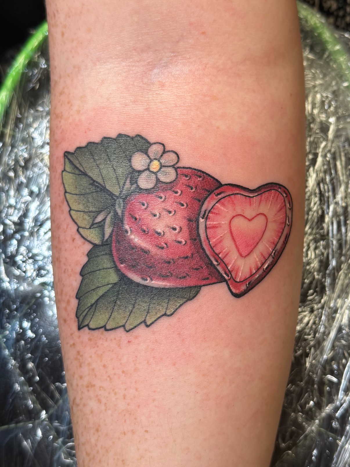 Strawberry heart realism tattoo on the forearm by Dee - MA Tattoo Artist, Concord, Massachusetts