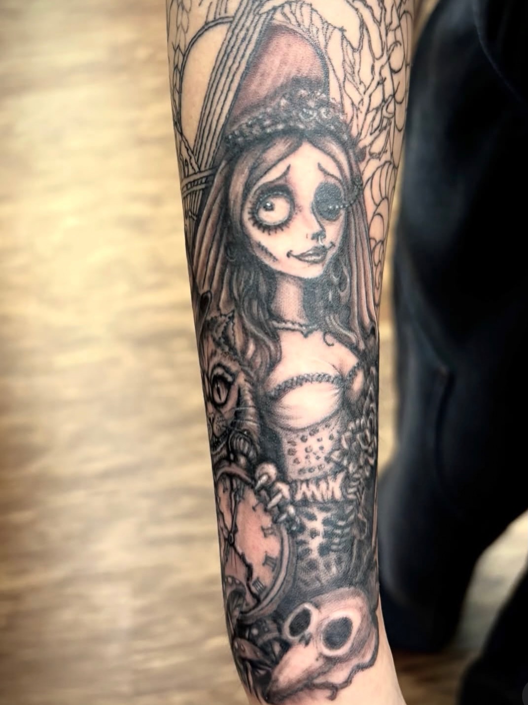 Girl with skull realism tattoo on the forearm by Thom Johns-Green