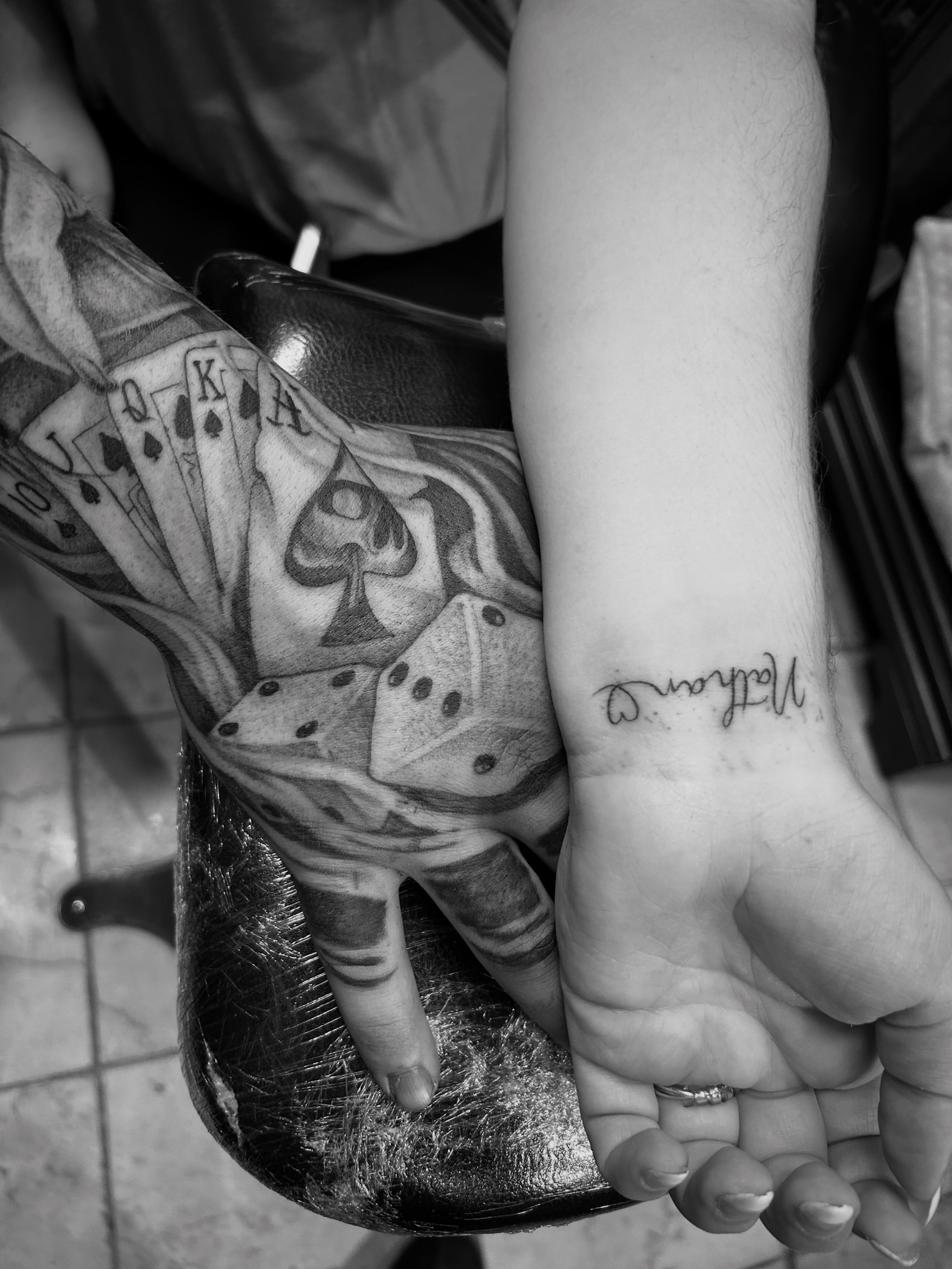Playing cards and dice black and grey tattoo on the forearm by Marky