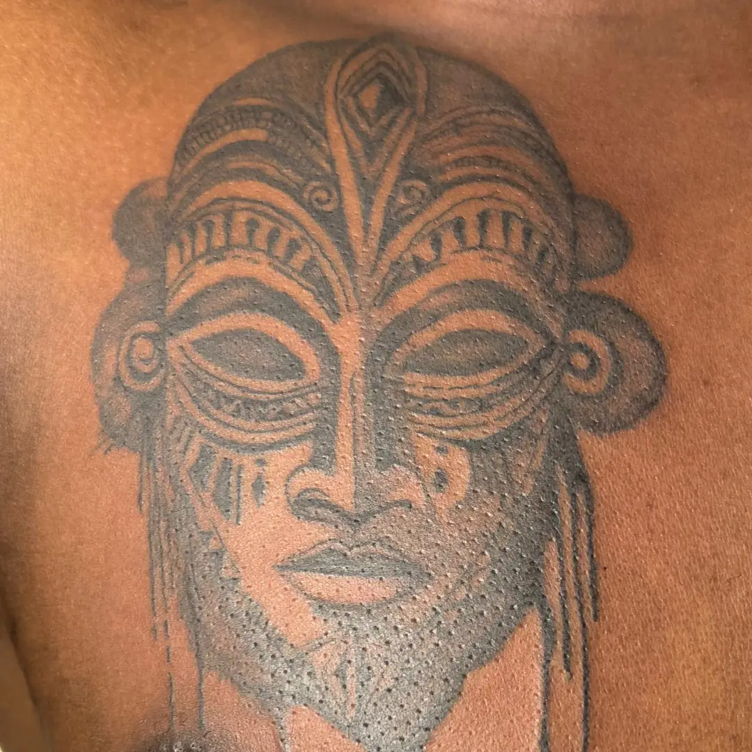 Mask dotwork tattoo on the chest by Mwangaza Bodyworks, Uthiru, Nairobi Area, Kenya