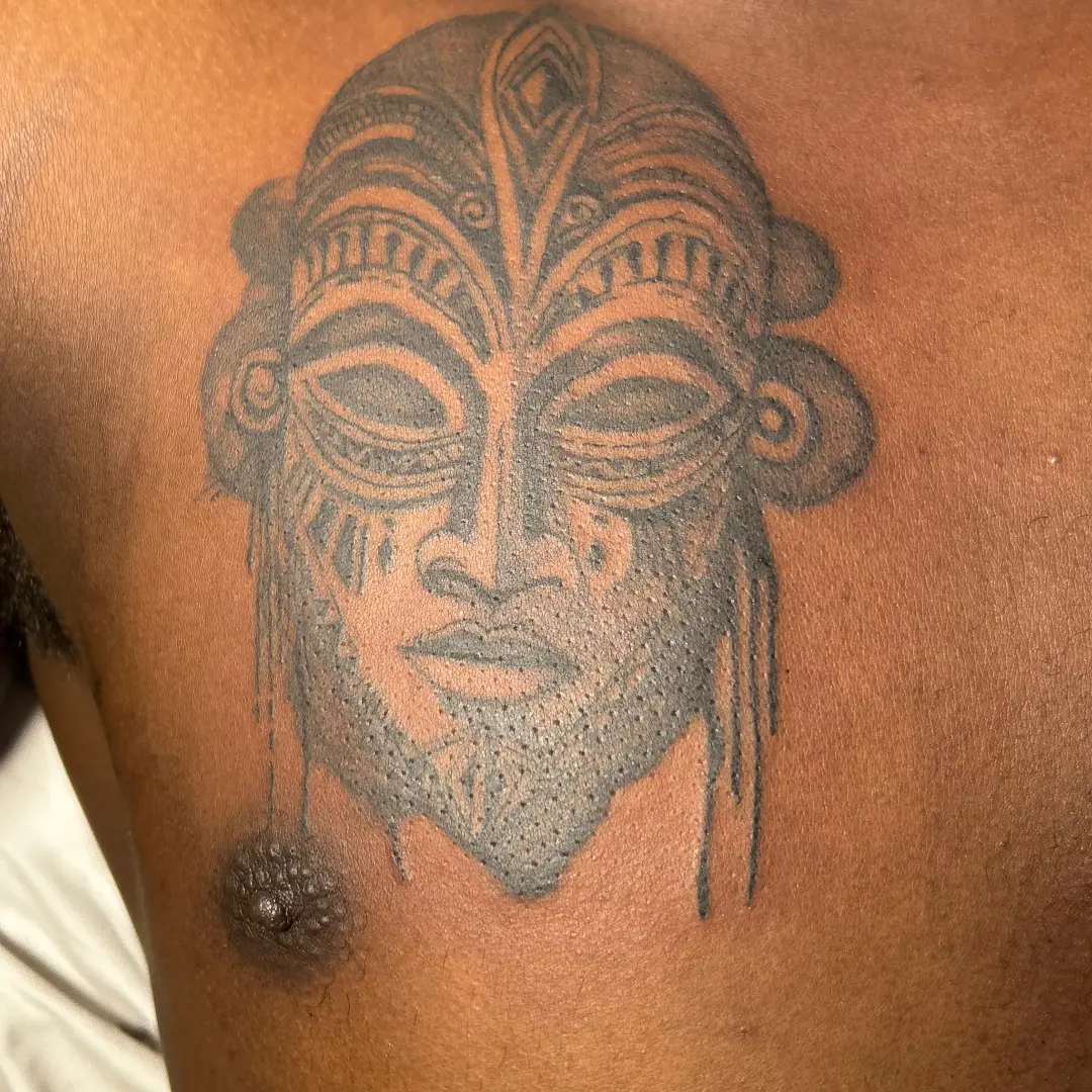 Mask dotwork tattoo on the shoulder by Mwangaza Bodyworks, Uthiru, Nairobi Area, Kenya