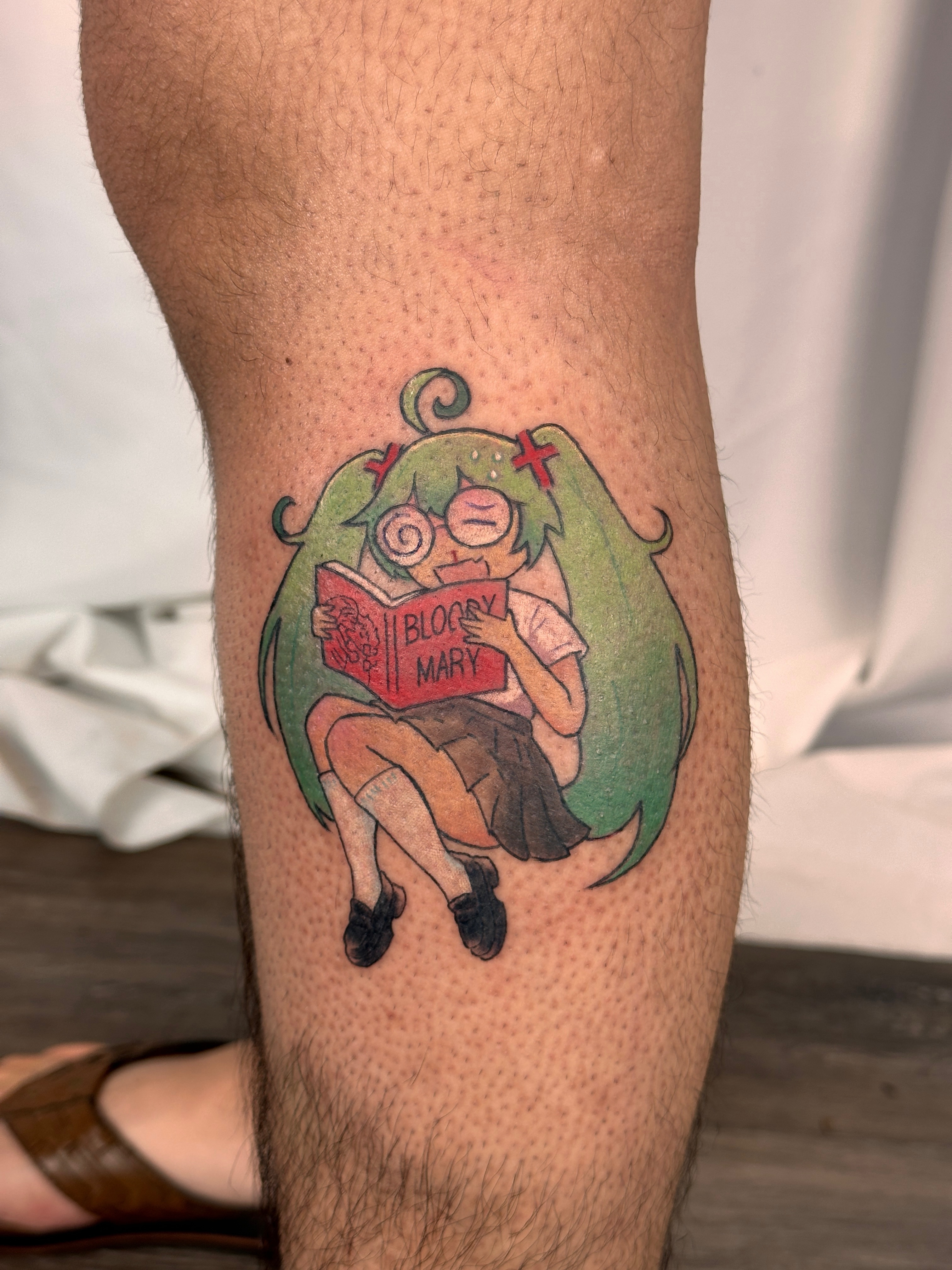 Girl reading anime tattoo on the forearm by Shrimple