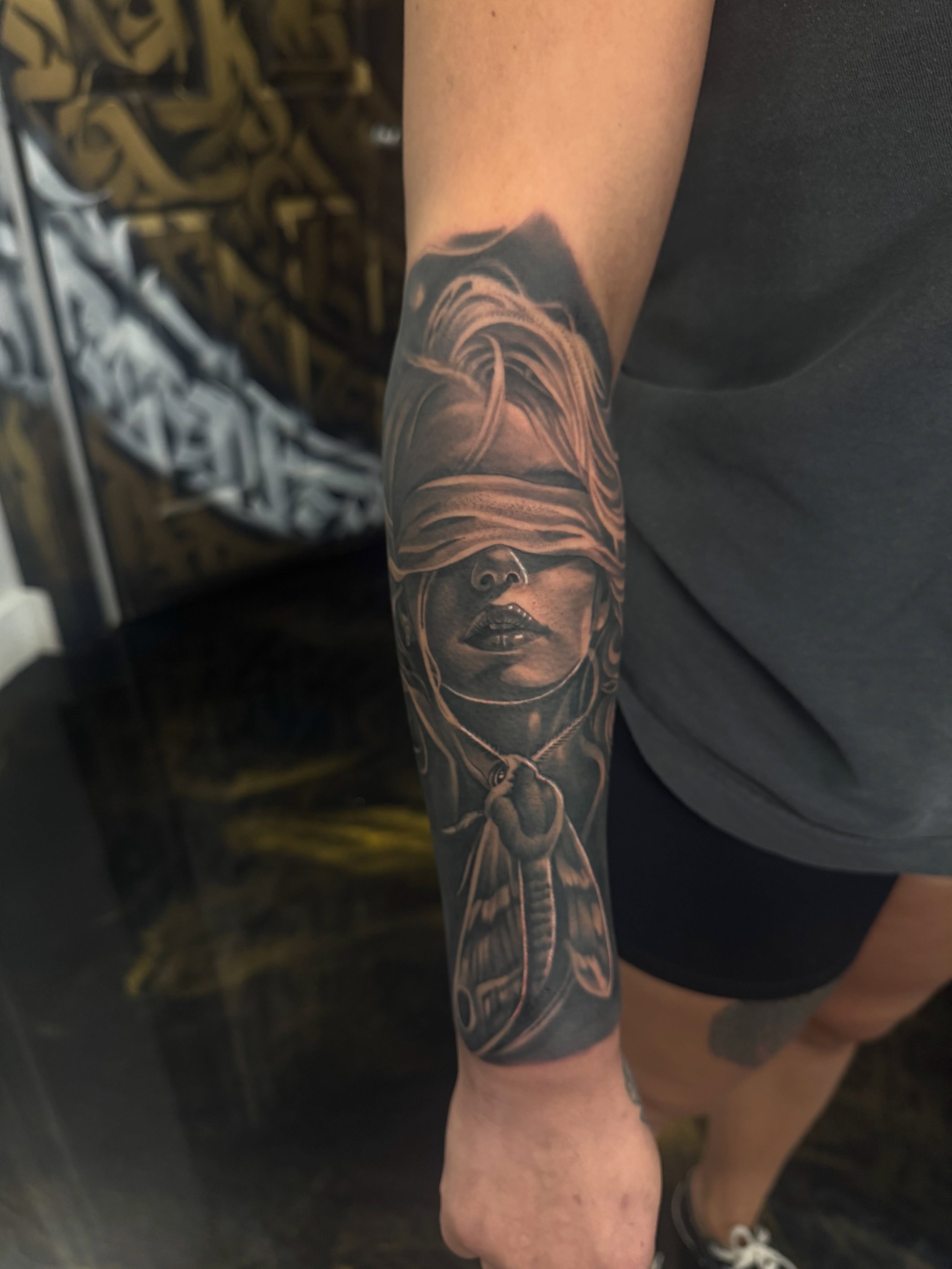 Blindfolded woman realism tattoo on the forearm by Fernando Luna