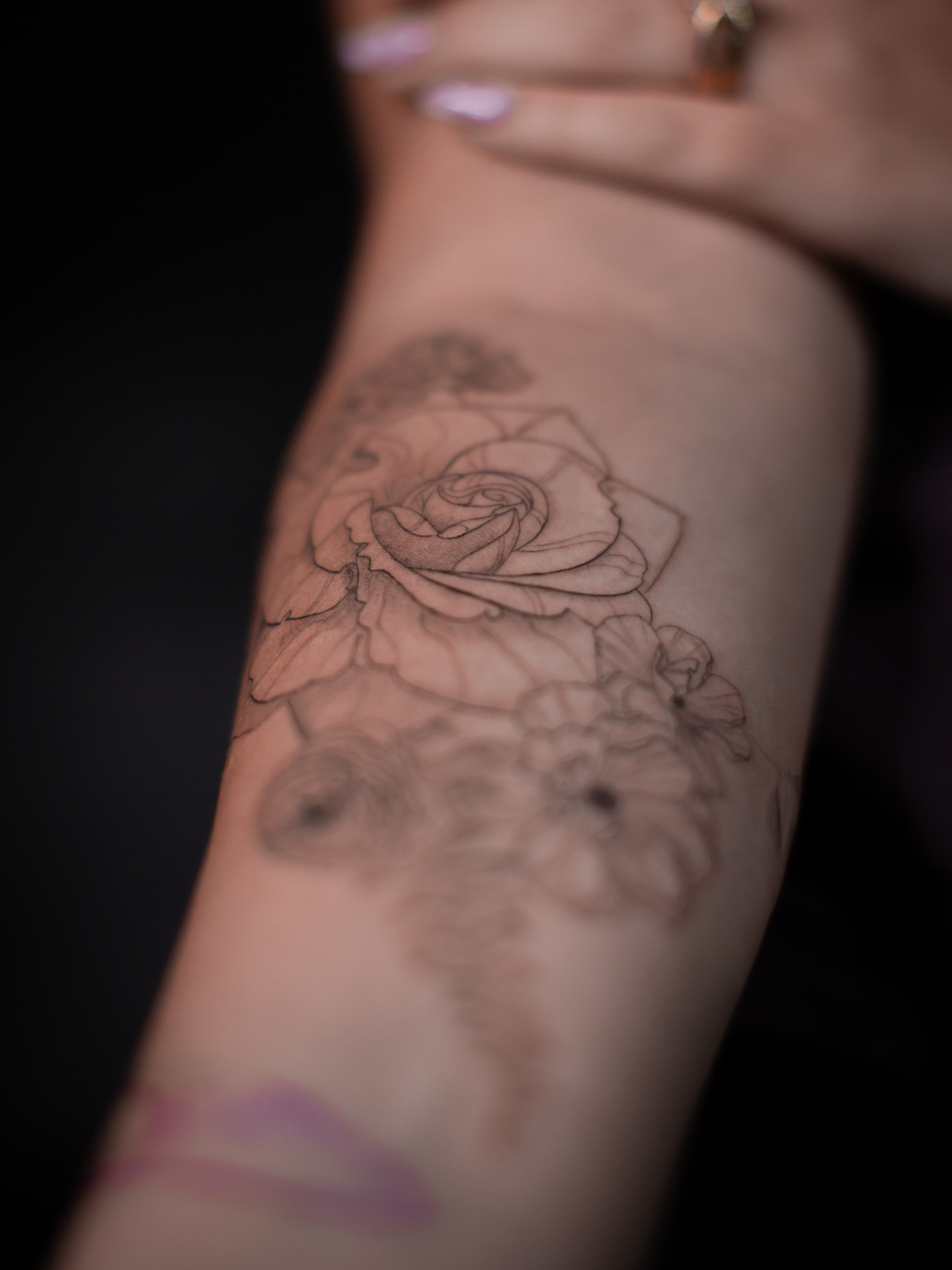 Rose black and grey tattoo on the forearm by Aries Rising