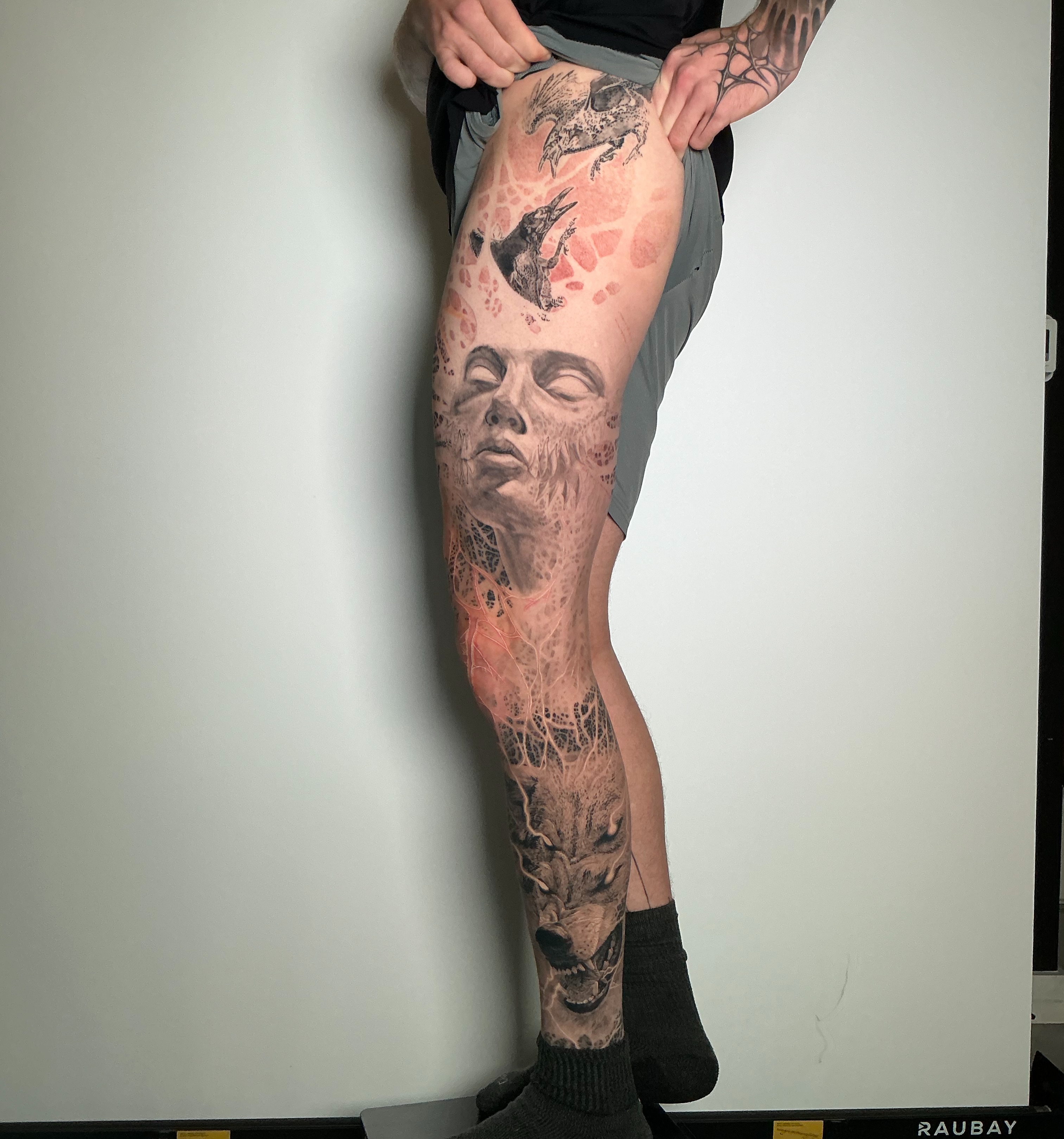 Abstract human face realism tattoo on the leg by Dan Sprague