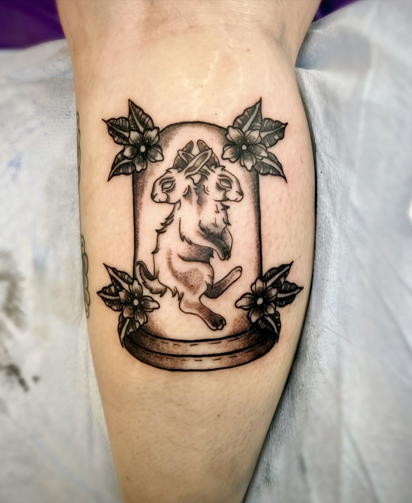 Goat and flowers black and grey tattoo on the forearm by Shay Cole