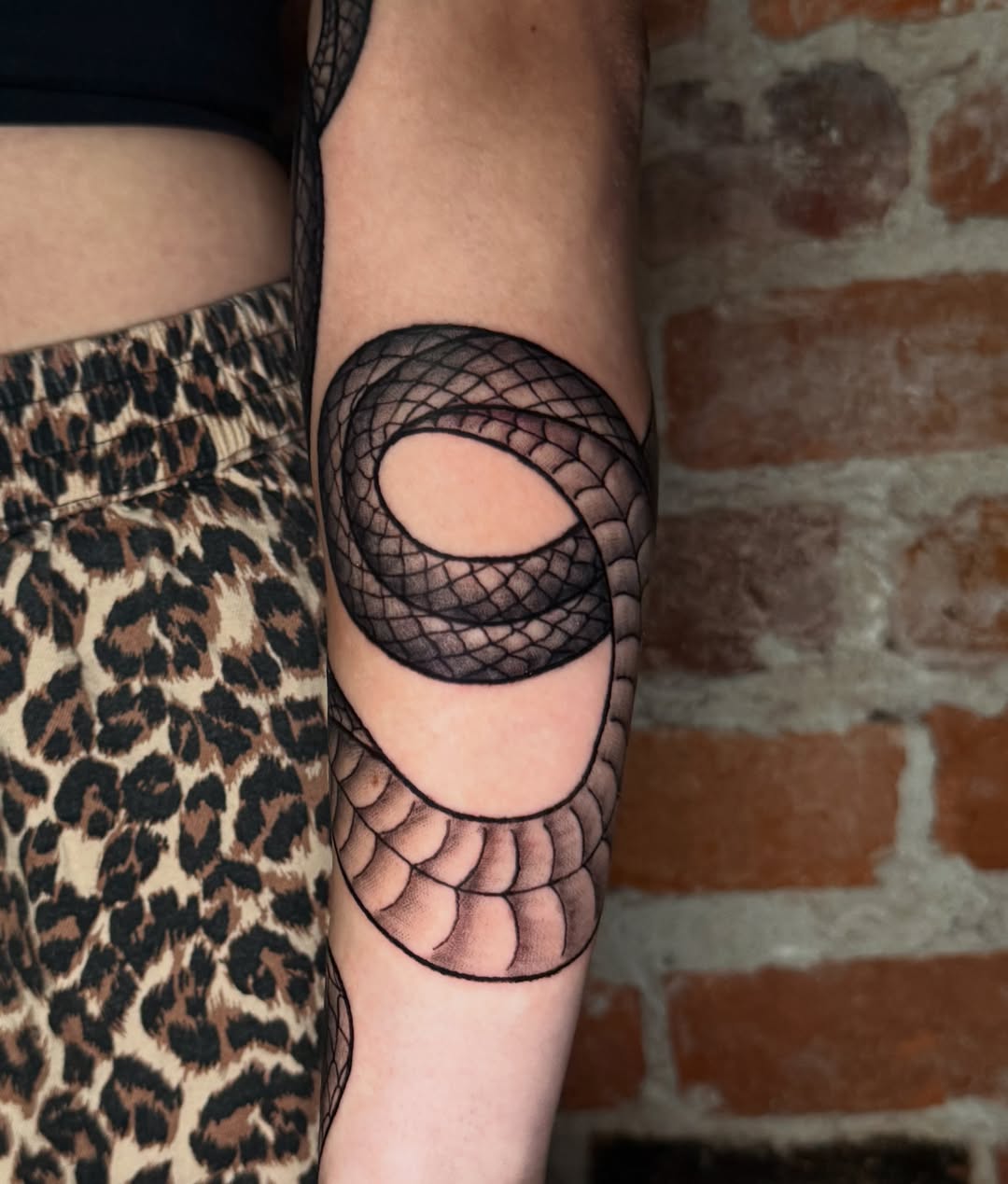 Snake geometric tattoo on the forearm by CAT