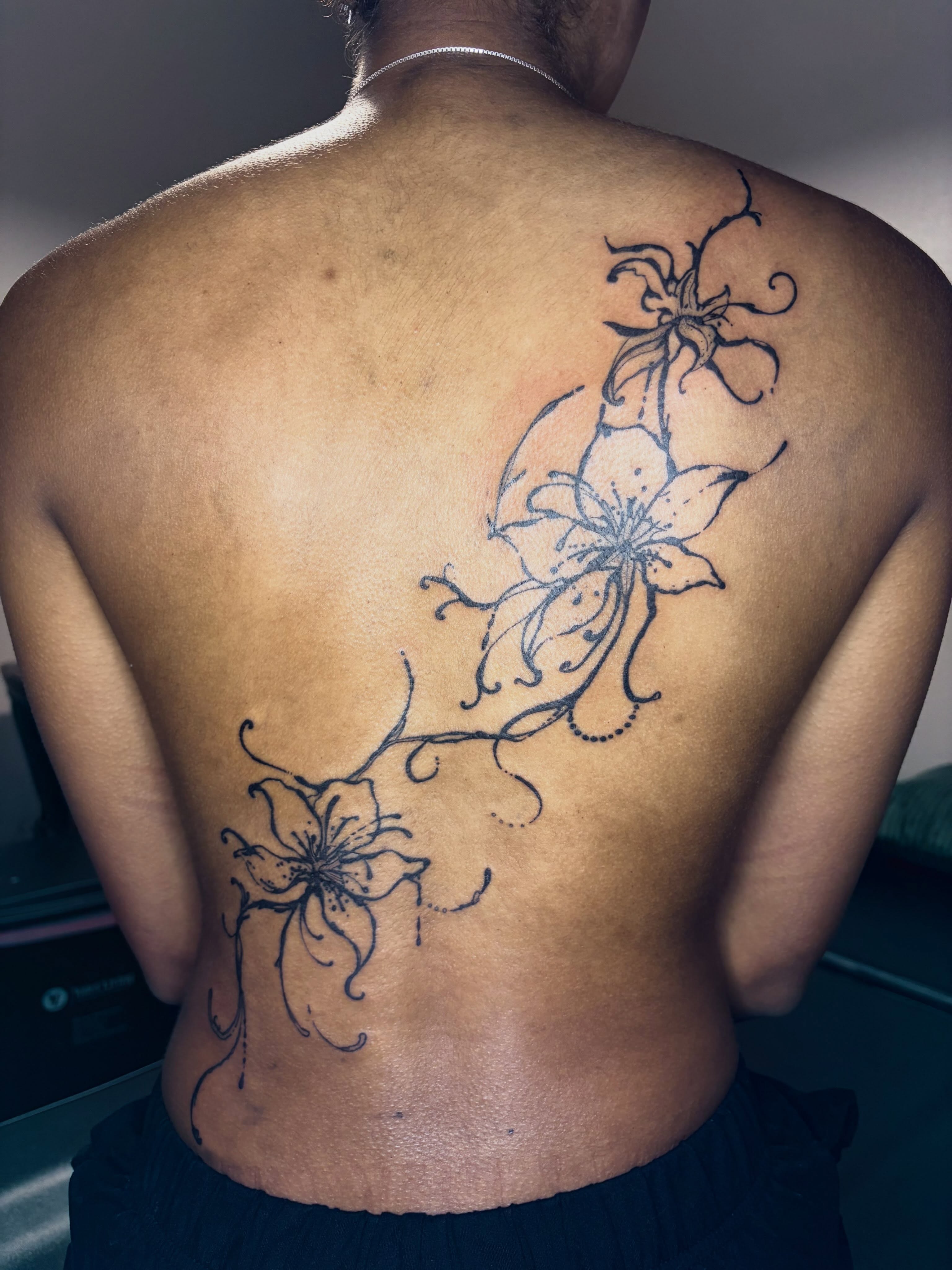 Lily flowers black and grey tattoo on the back by blastedbybk