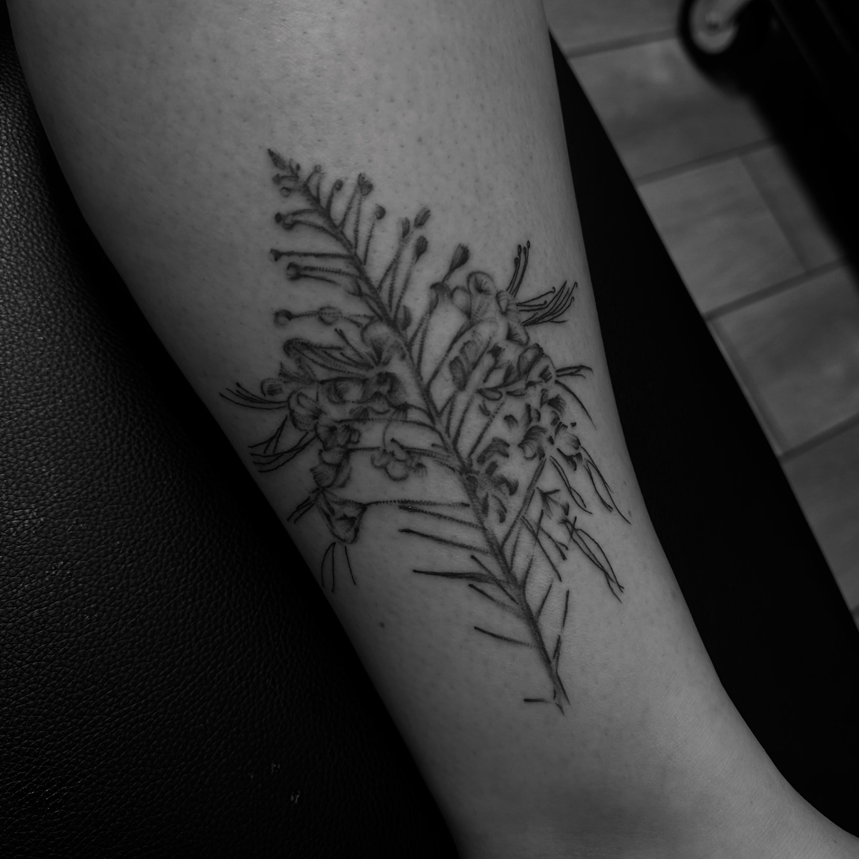 Flower arrangement black and grey tattoo on the forearm by Marly Quinn