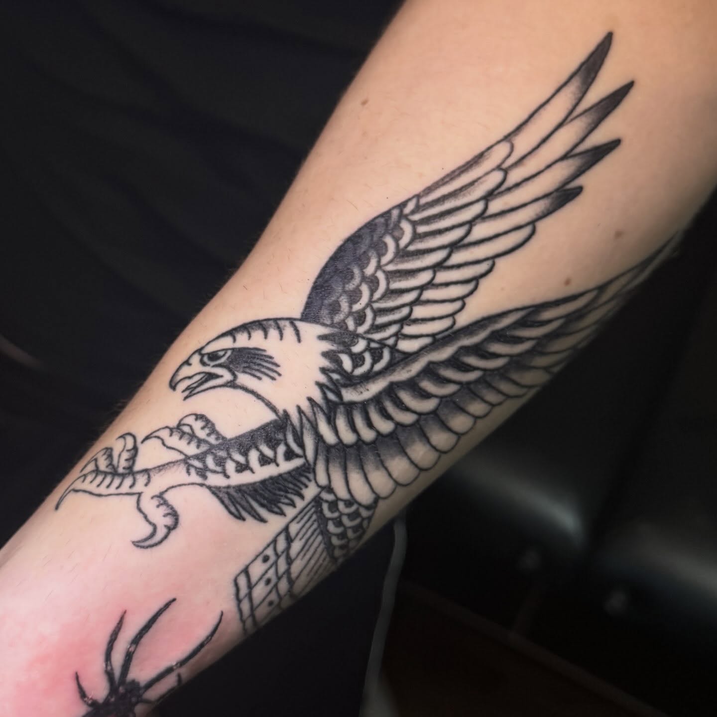 Flying eagle American traditional tattoo on the forearm by Mtctattoos