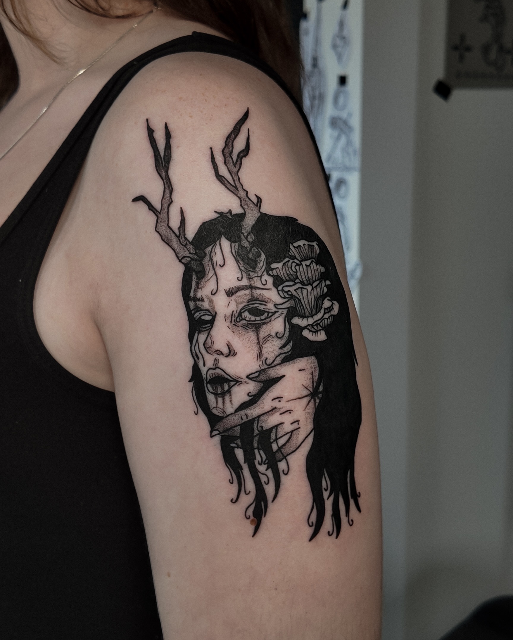 Woman with antlers dark realism tattoo on the shoulder by Morgan Diann