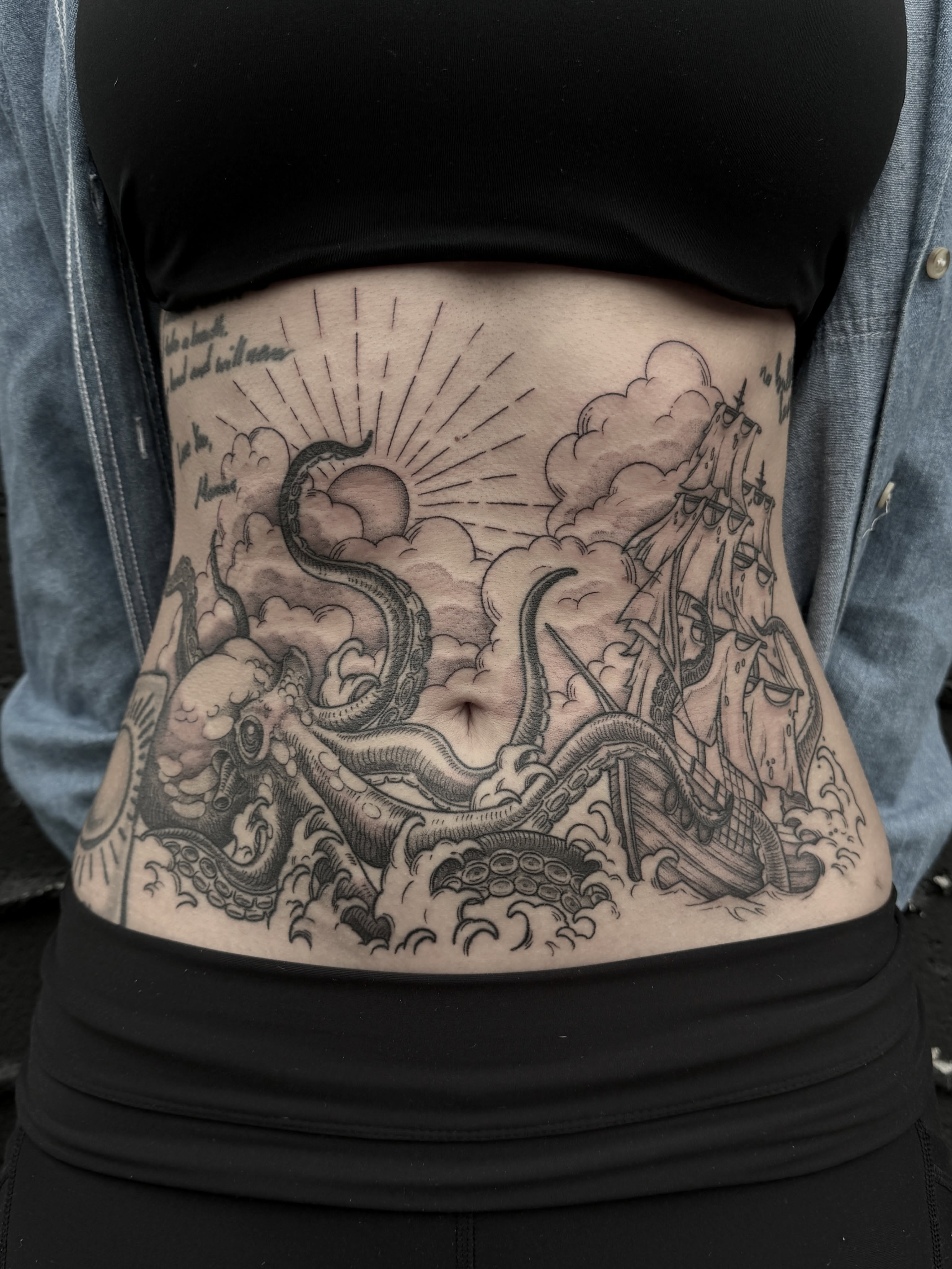 Ship and octopus black and grey tattoo on the torso by Hannah May, La Mesa, California