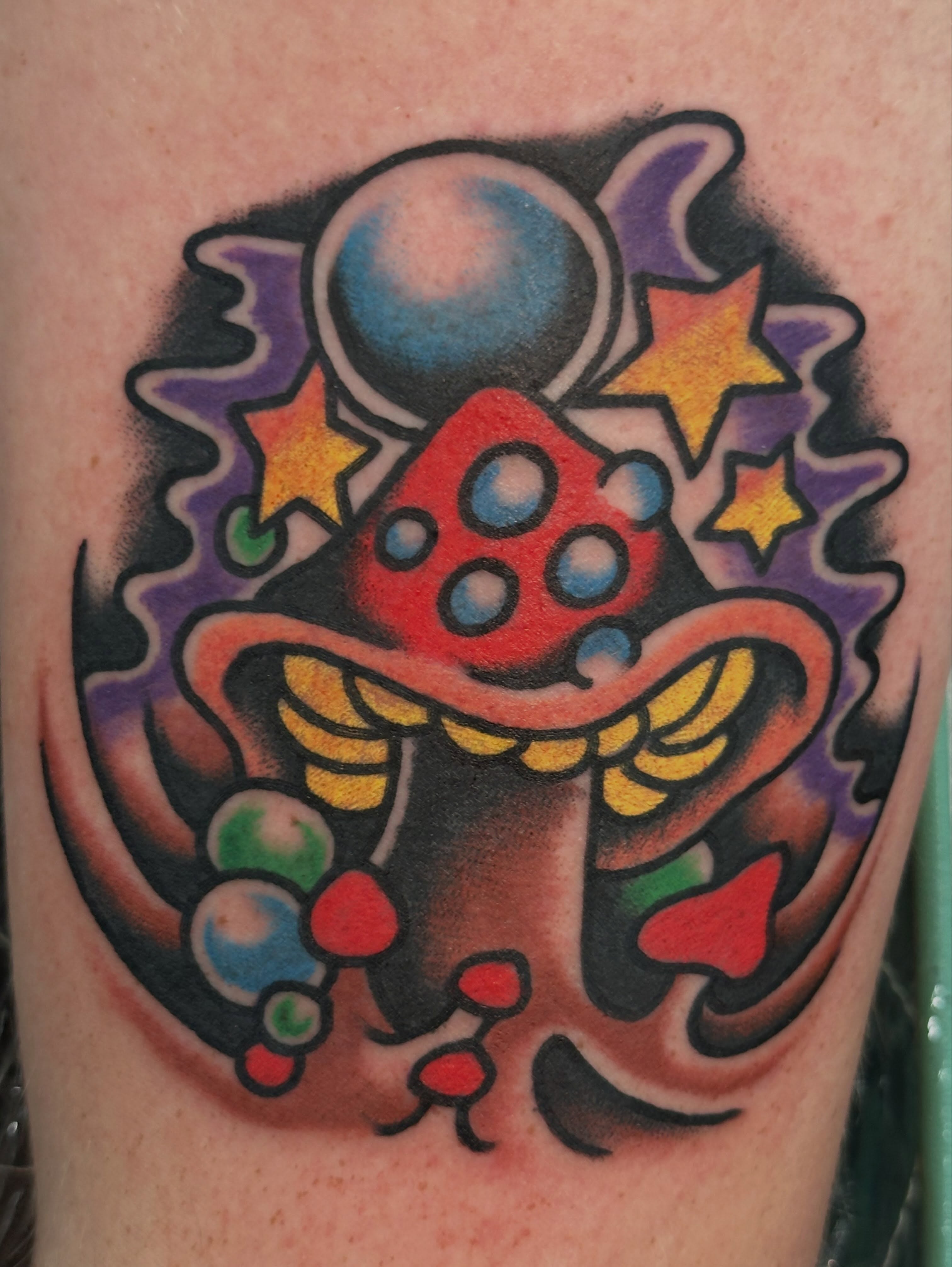 Space mushroom American traditional tattoo on the forearm by Cody Woolard, Seymour, Tennessee