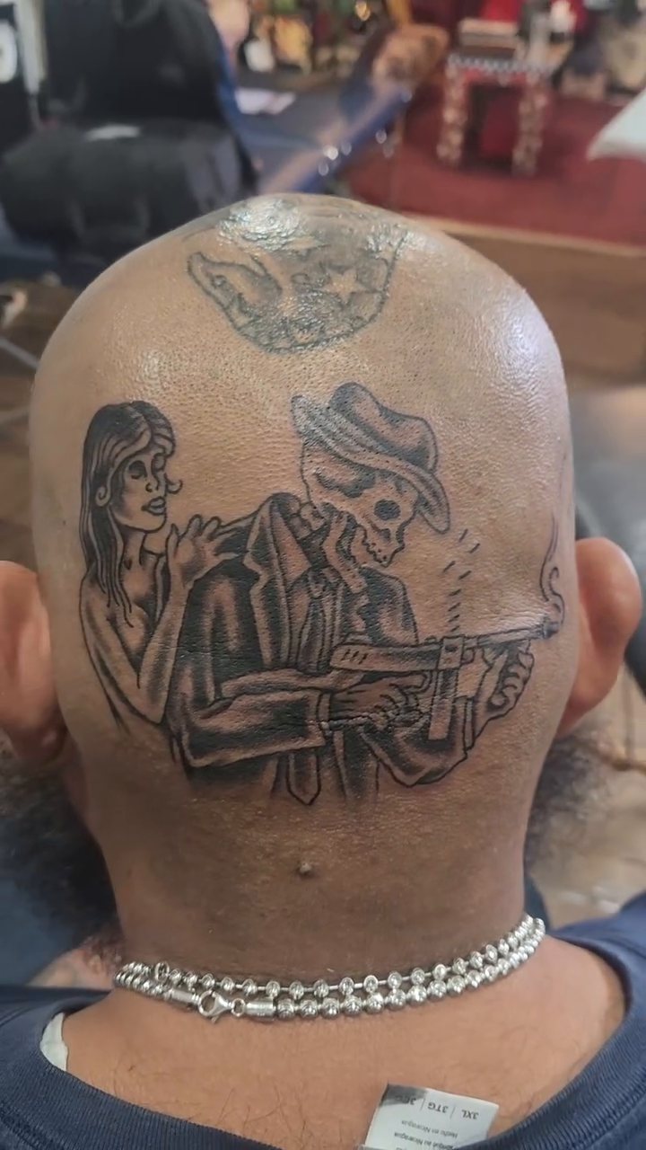 Skeleton couple with guns tattoo on the head by Douglas Grady