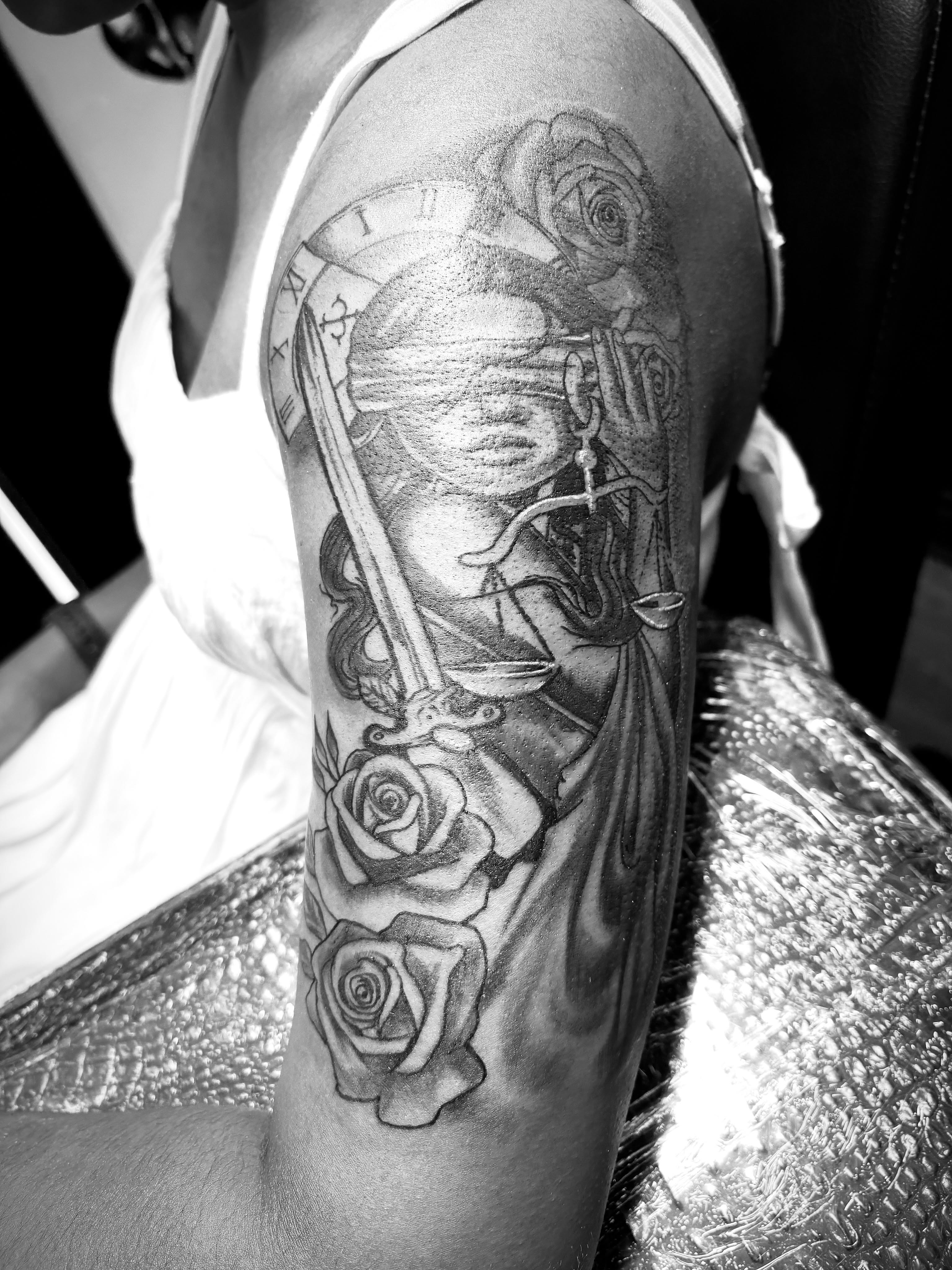 Lady Justice with roses realism tattoo on the forearm by Shine Jefferson, Memphis, Tennessee
