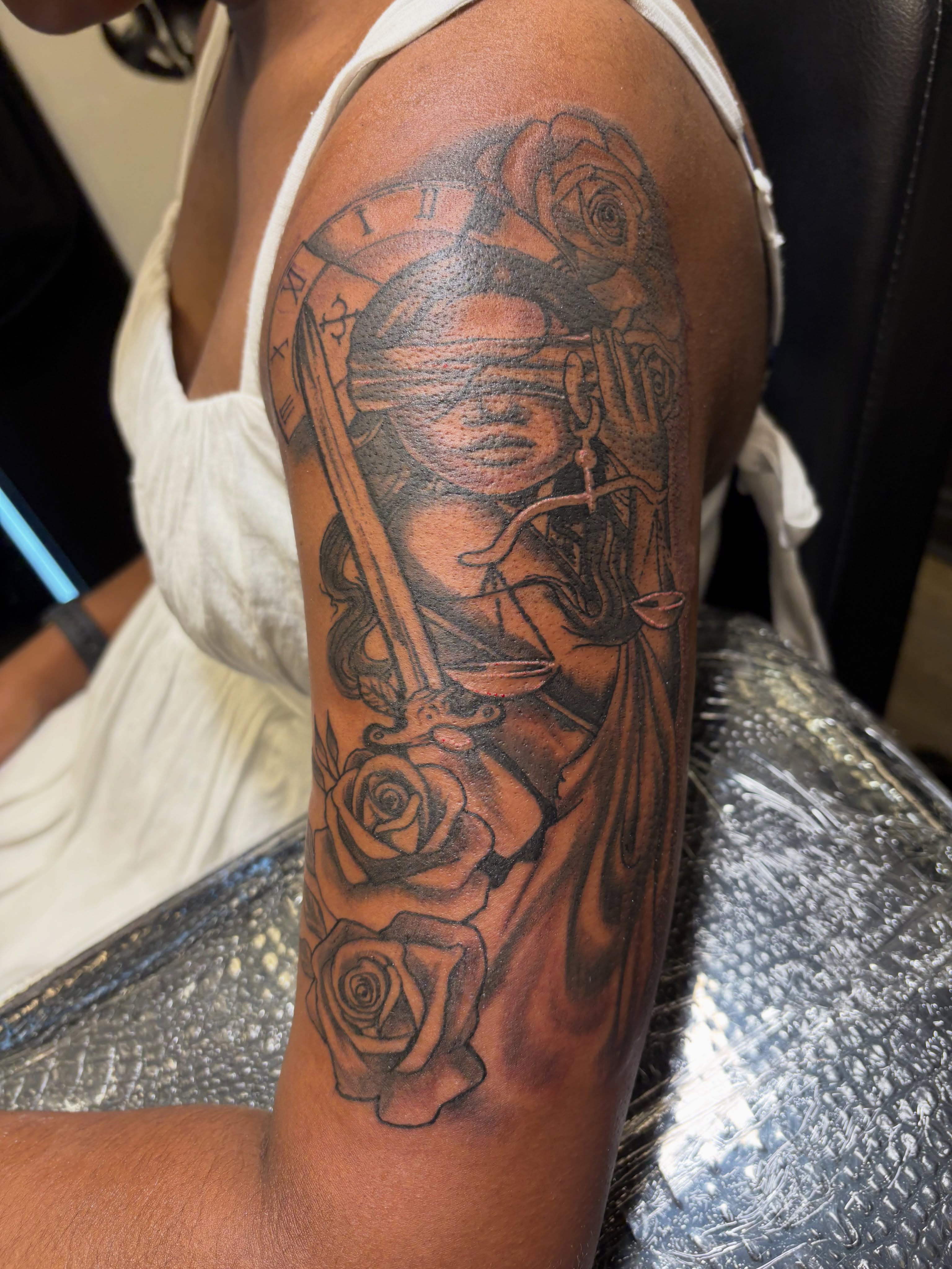 Lady Justice with roses realism tattoo on the forearm by Shine Jefferson, Memphis, Tennessee
