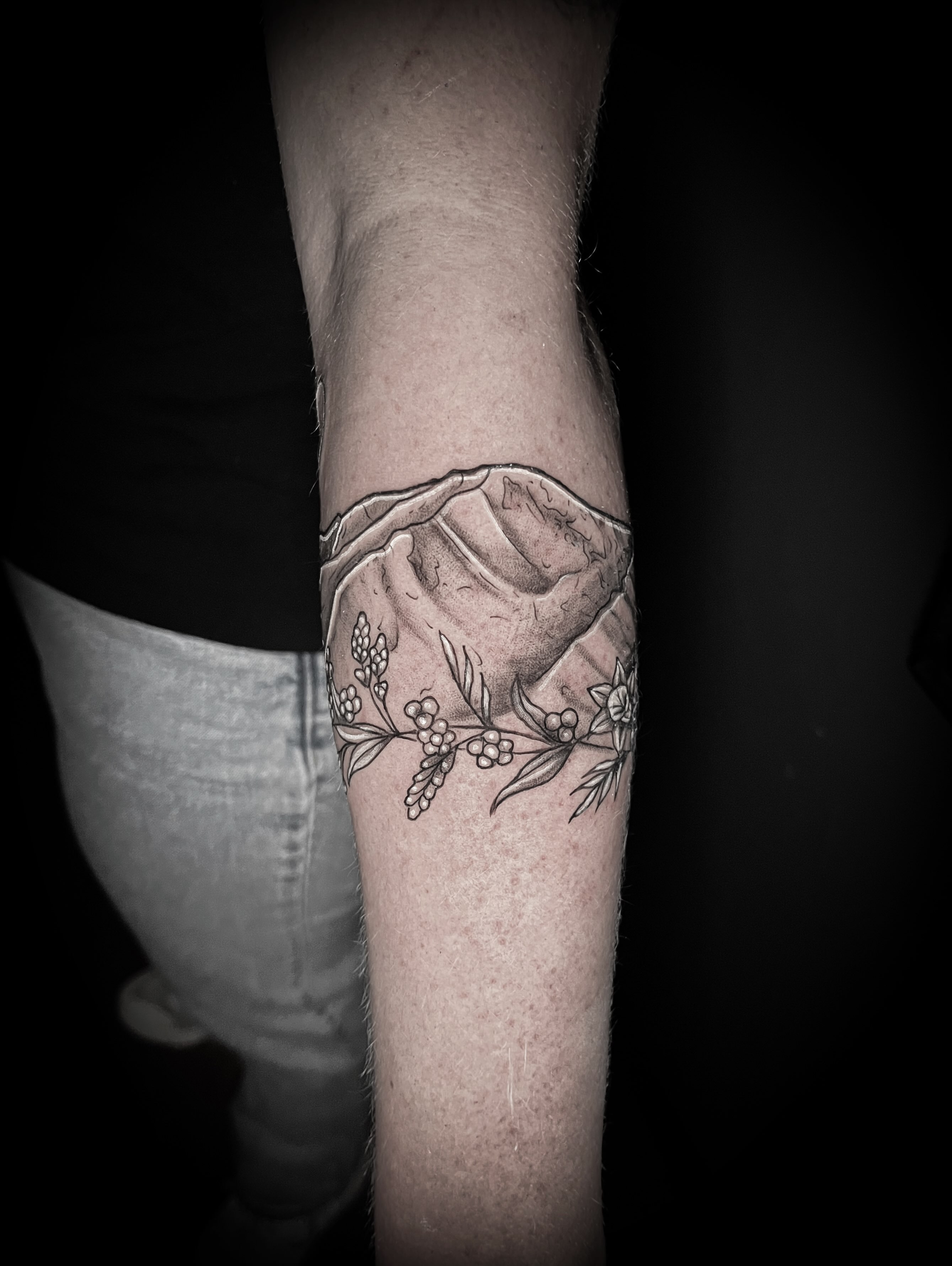 Mountain and floral black and grey tattoo on the forearm by Lindsay Fernandez, Colorado Springs, Colorado