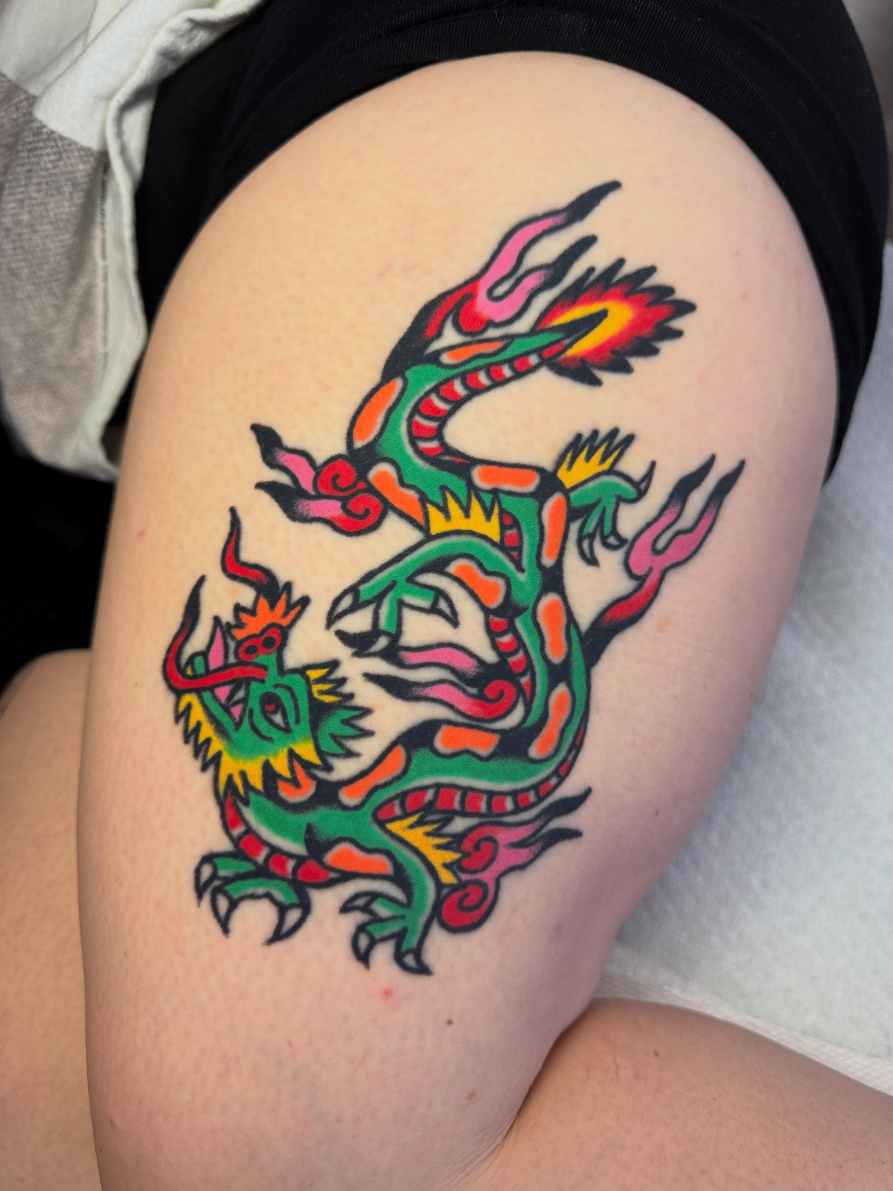 Dragon American traditional tattoo on the thigh by Britt Kuechenmeister, Culver City, California
