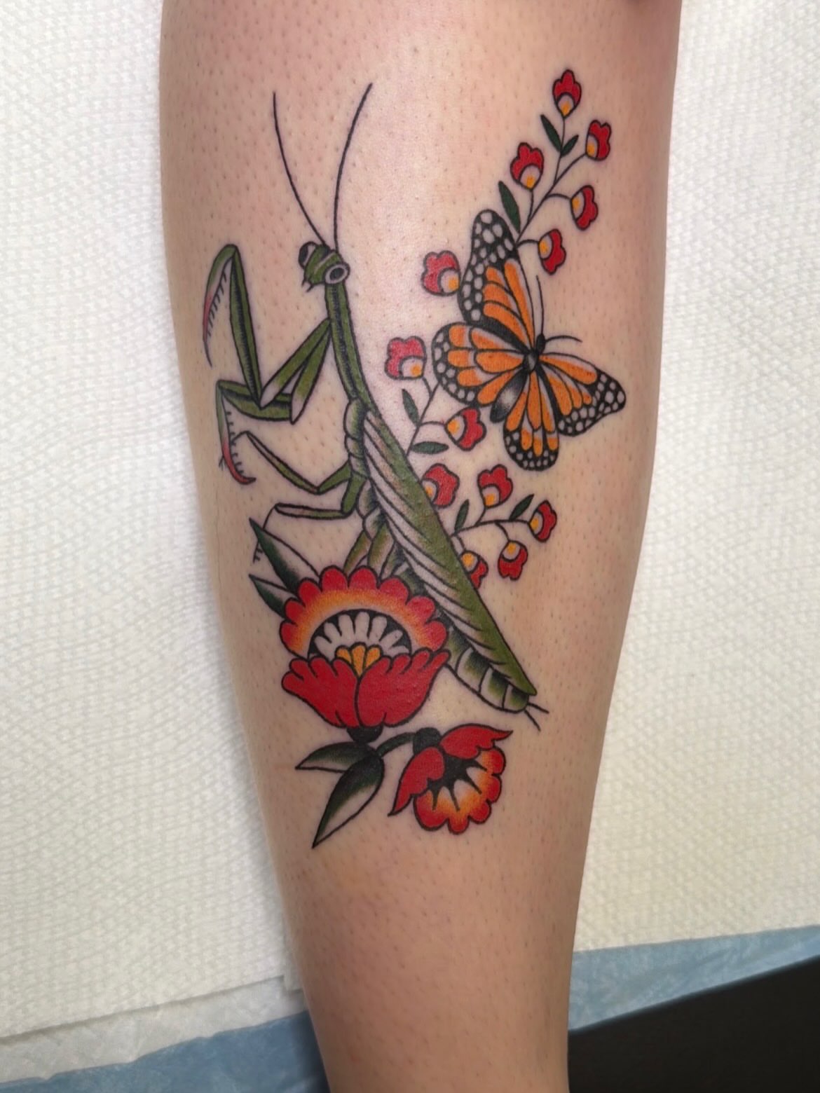Praying mantis and butterfly American traditional tattoo on the forearm by Emma Fox Tattoo
