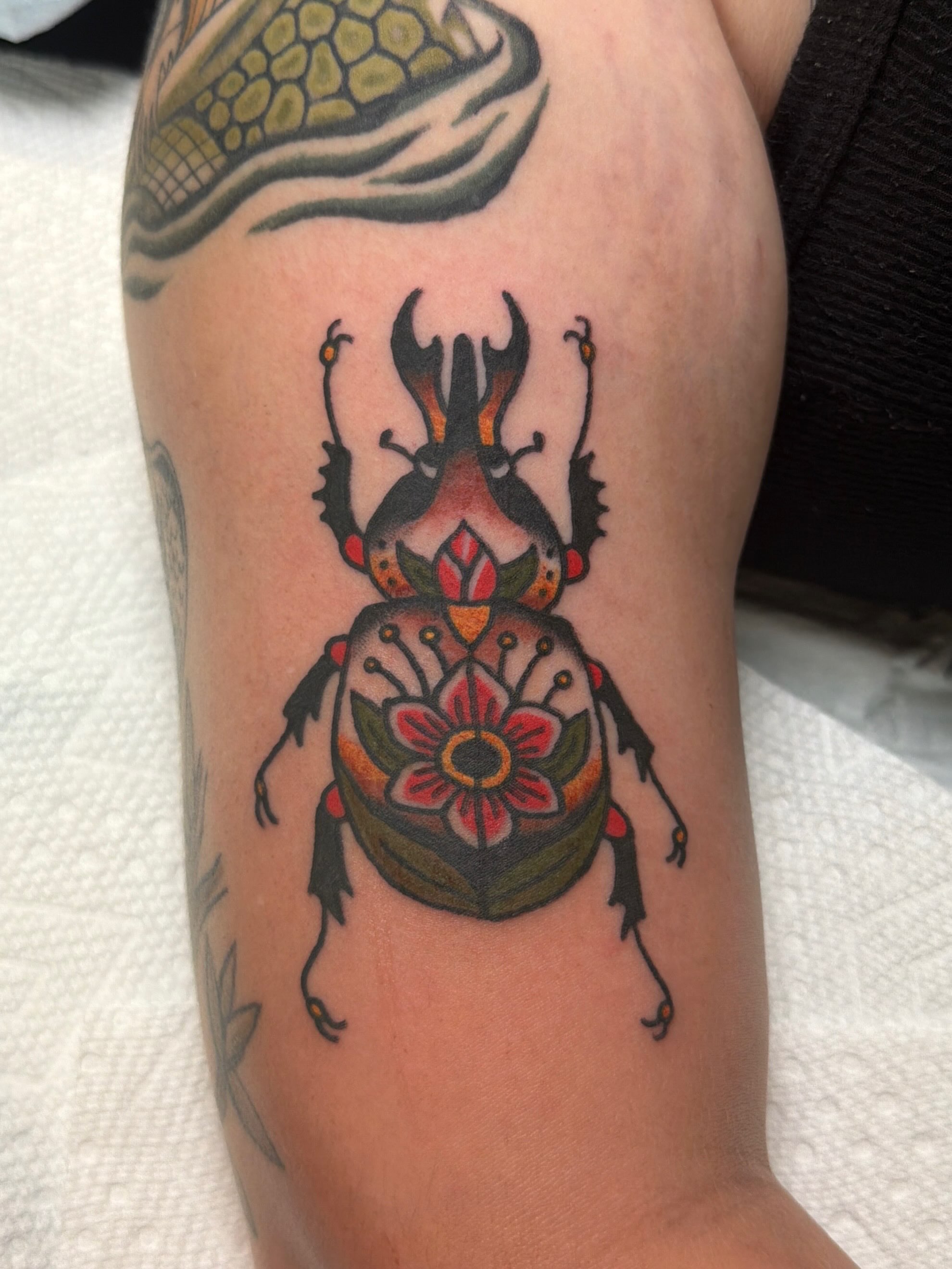 Beetle American traditional tattoo on the forearm by Emma Fox Tattoo
