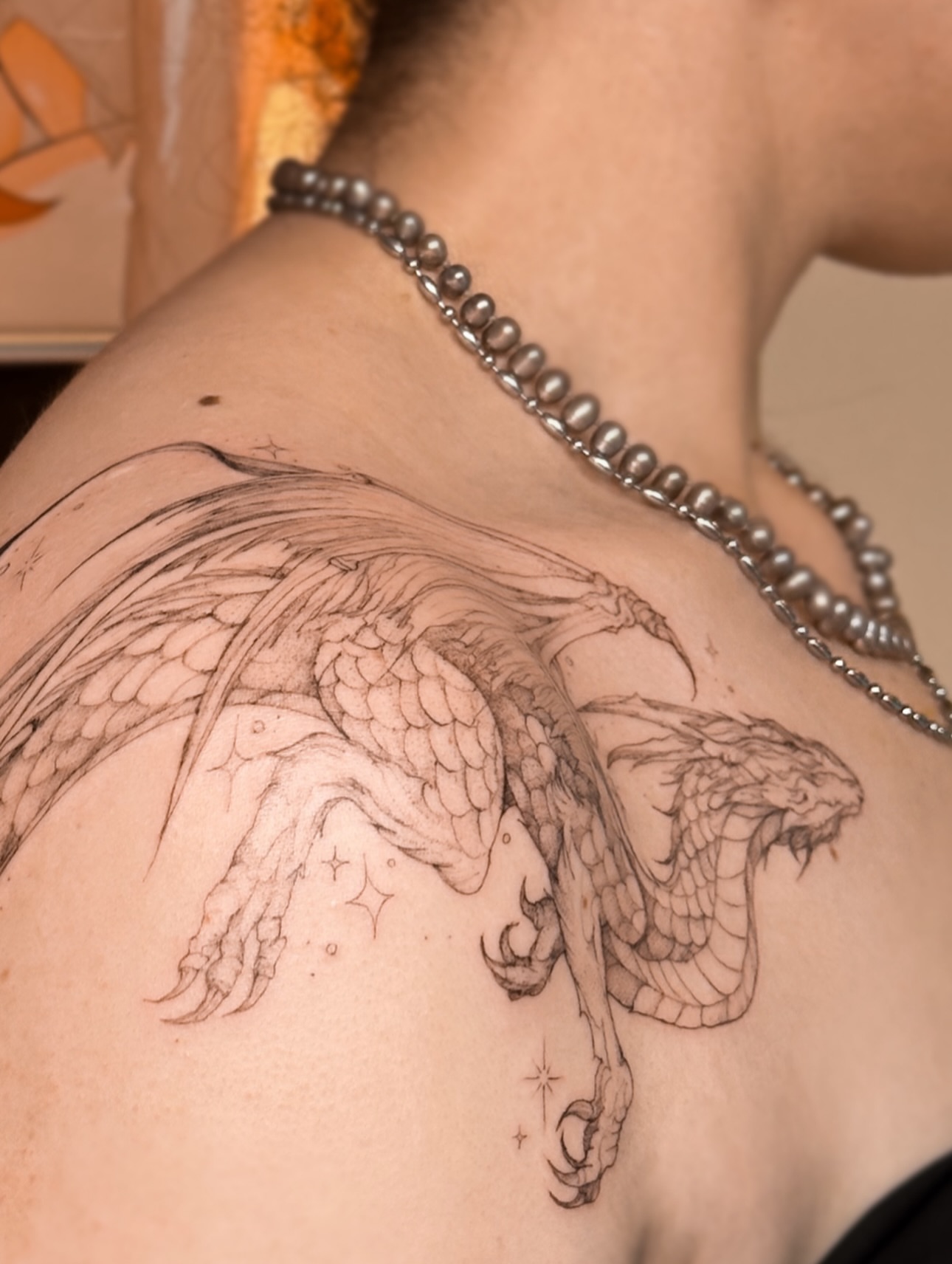 Dragon black and grey tattoo on the shoulder by Mila, Riga, Latvia