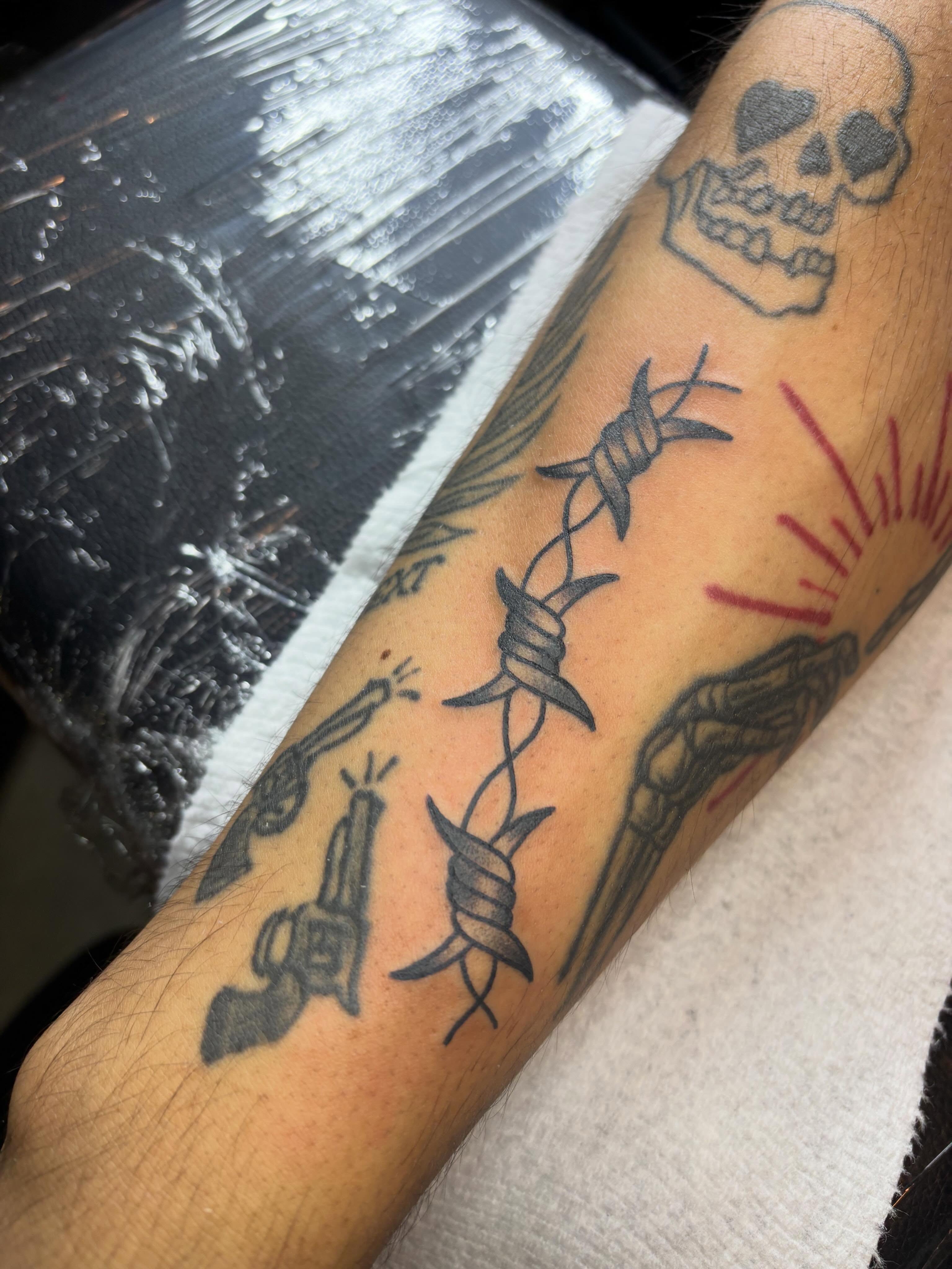 Barbed wire black and grey tattoo on the forearm by Malia Clark