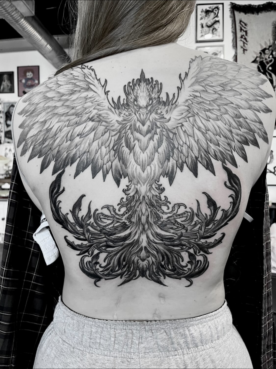 Phoenix black and grey tattoo on the back by Nathan Esteras