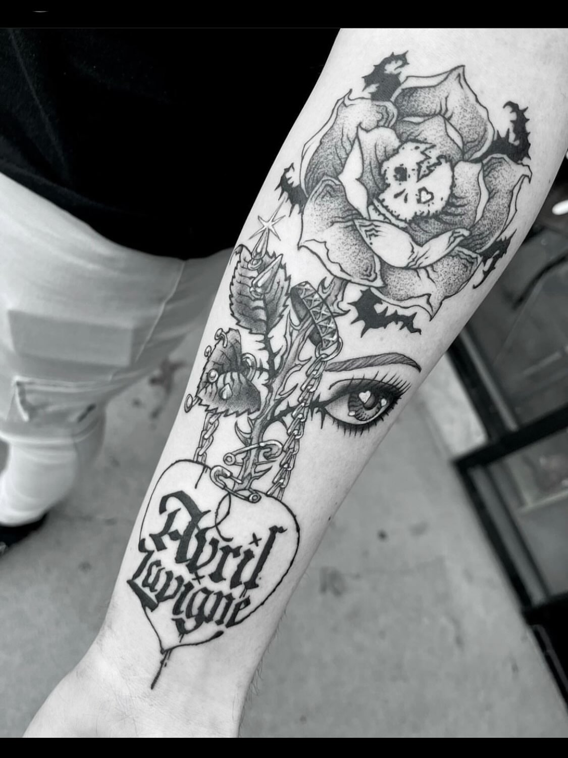 Flower and skull dark realism tattoo on the forearm by Nathan Esteras